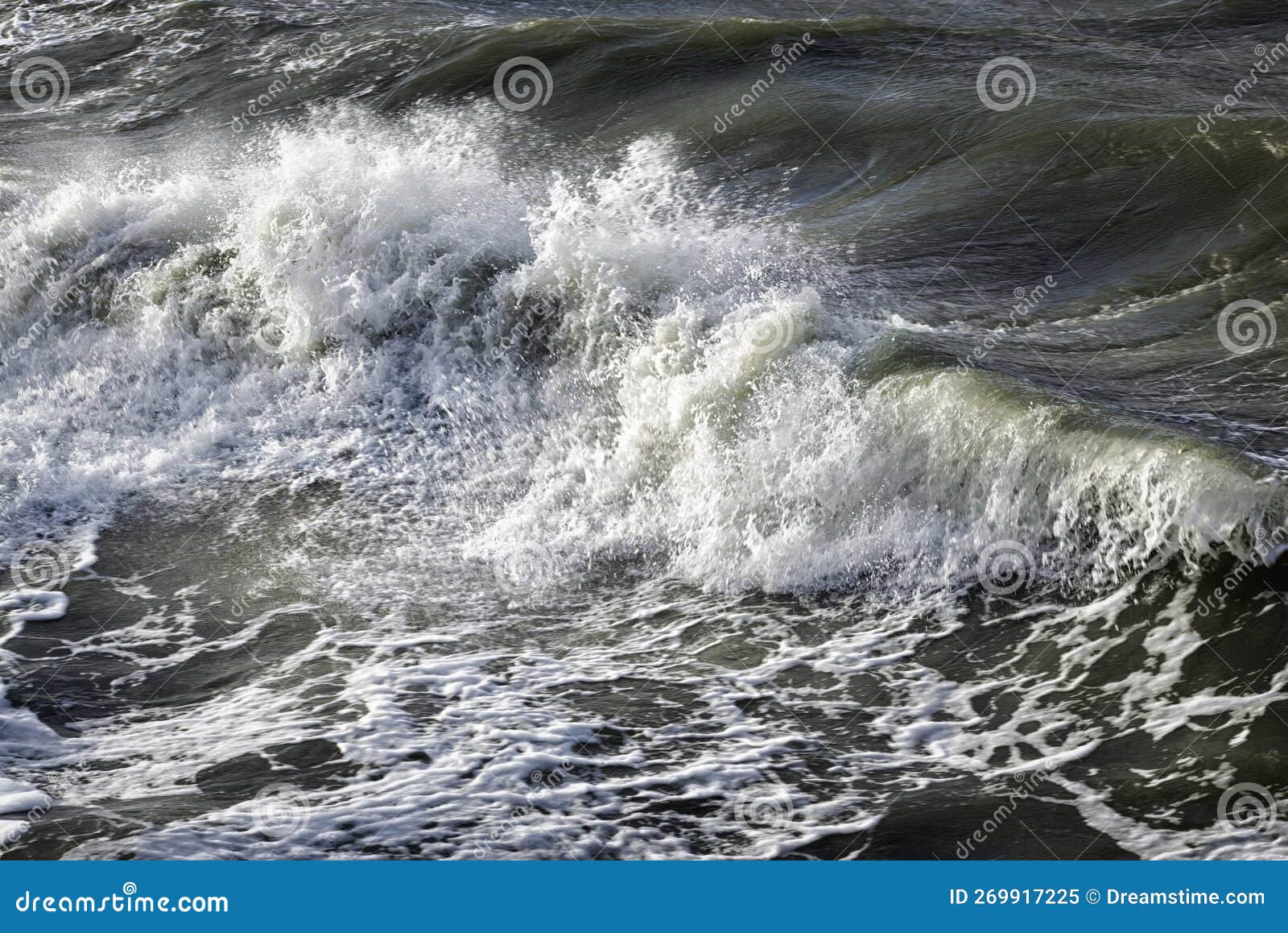 Stormy Baltic Sea at Sunset. Dramatic Sky, Glowing Clouds, Waves and Water Splashes. Stock Image