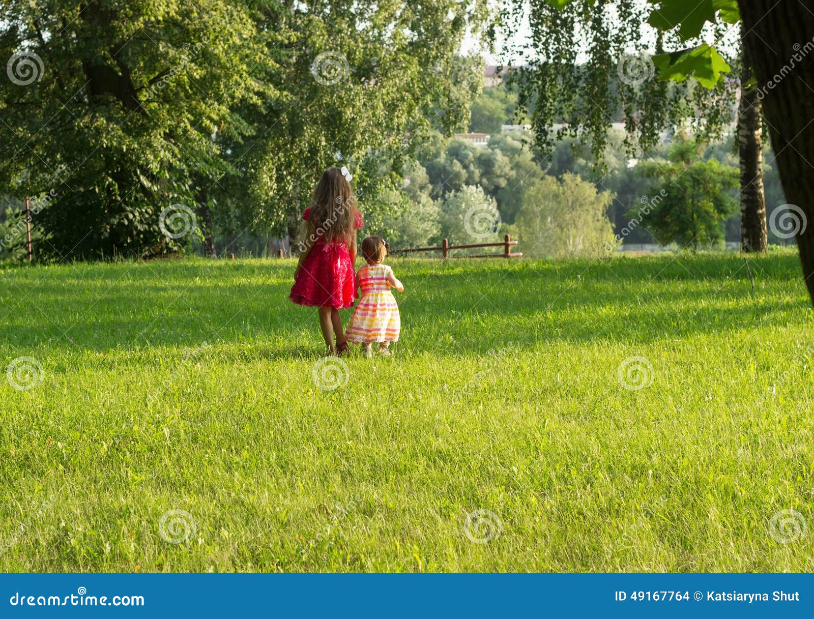 Bambine sveglie divertendosi al giorno di estate all'aperto