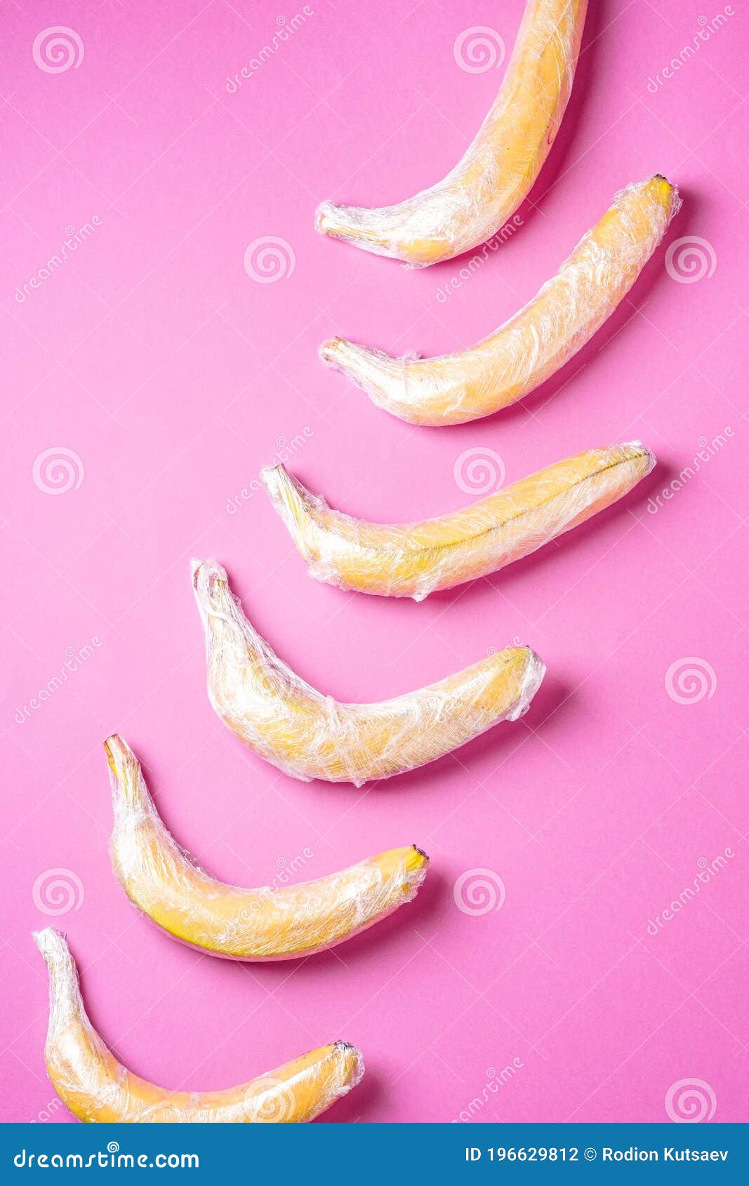 Banana Fruit Wrapped in Stretch Wrap Plastic on Pink Background