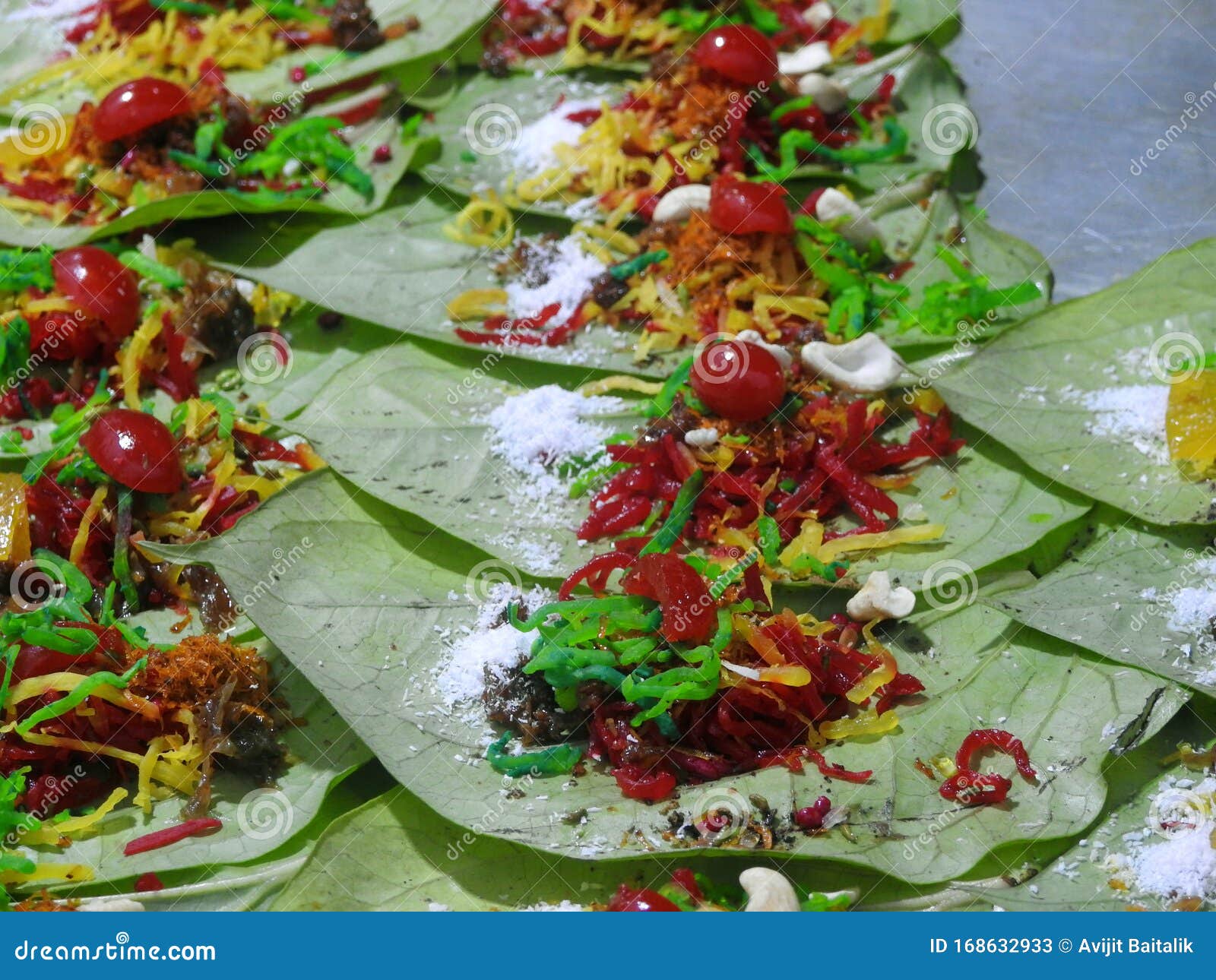 banarasi paan or betel leaf garnished with betel nut and all indian colorful banarasi ingredients for sale