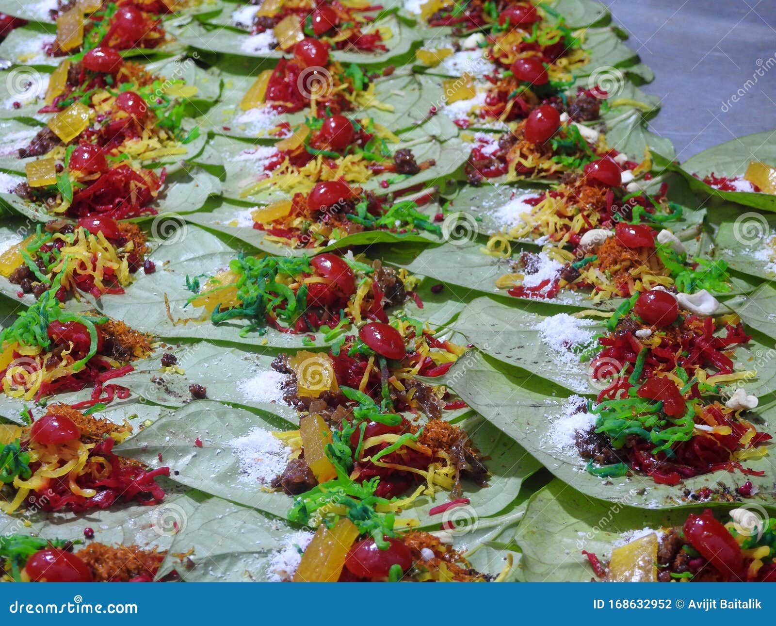 banarasi paan or betel leaf garnished with betel nut and all indian colorful banarasi ingredients for sale
