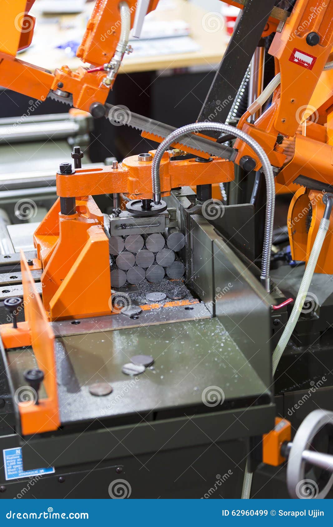 Band saw cutting steel bar stock image. Image of sawing 62960499