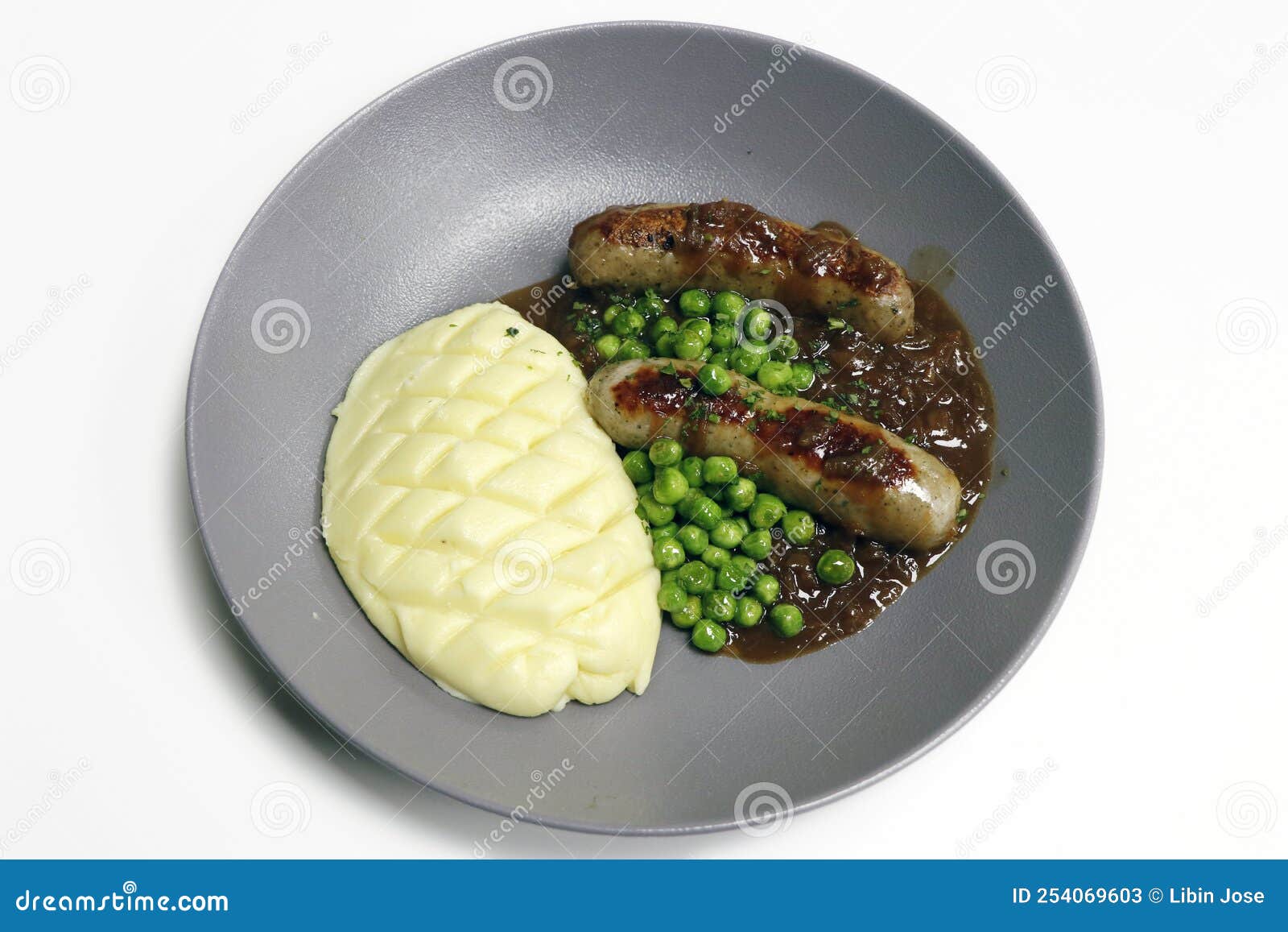 Bangers and Mash, Grilled Sausage with Mash Potato, Brown Onion Gravy and Steamed Green Peas Stock - of onion, background: