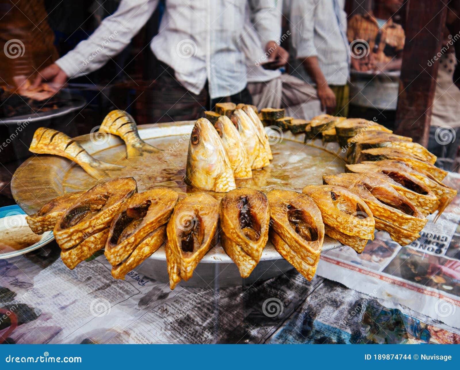 Bangladesh street food fish stew - Bengali local food in Dhaka city market. FEB 16, 2020 Dhaka, Bangladesh - Bangladesh street food fish stew on metal tray - Bengali local food selling in Dhaka city market