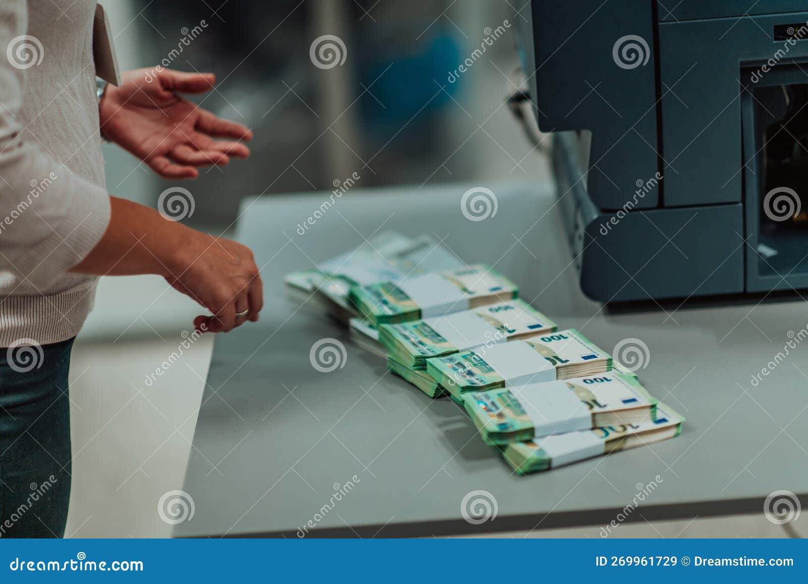 Bank Employees Using Money Counting Machine while Sorting and Counting