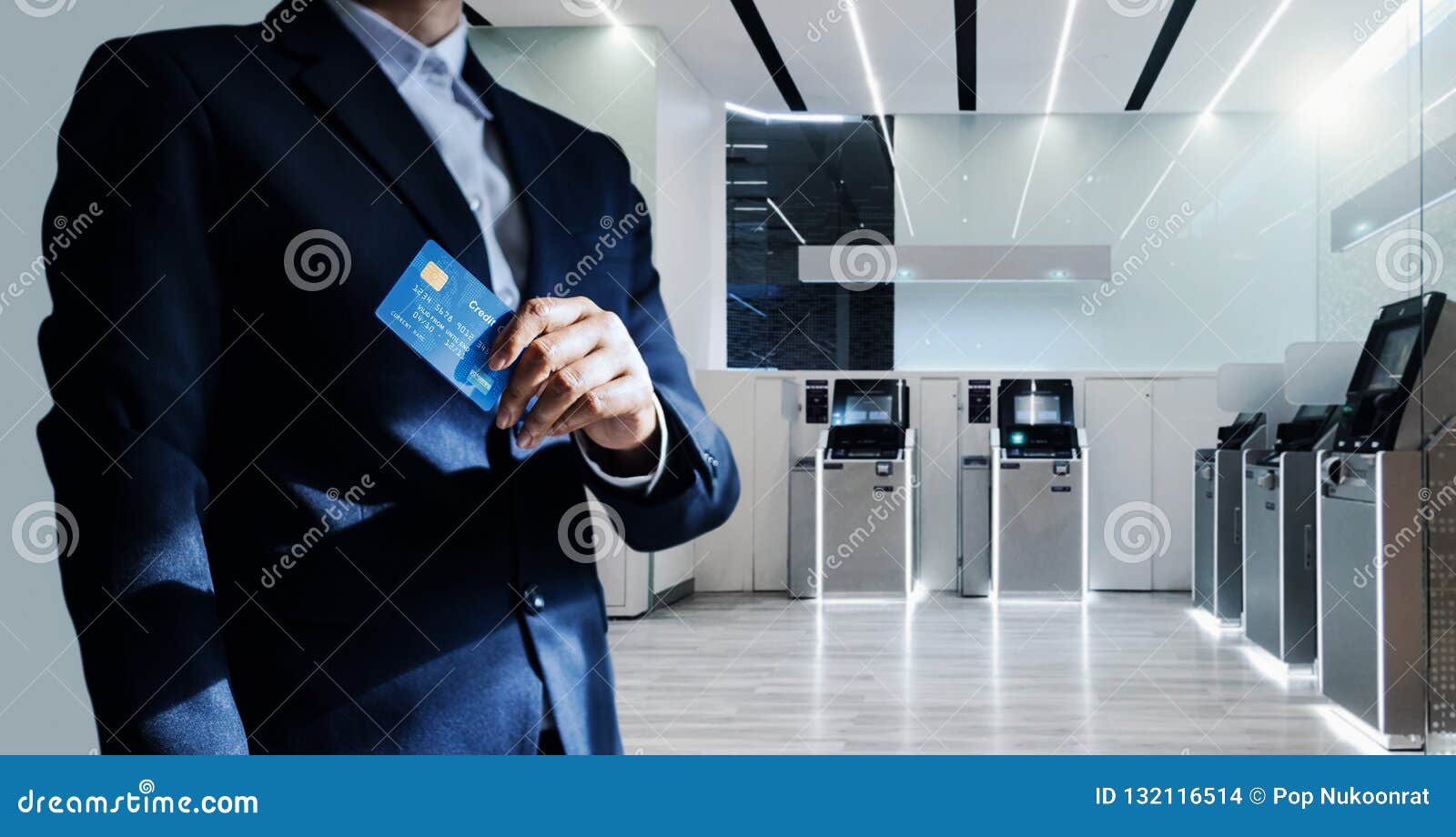 bank manager and credit card in hand standing confidently