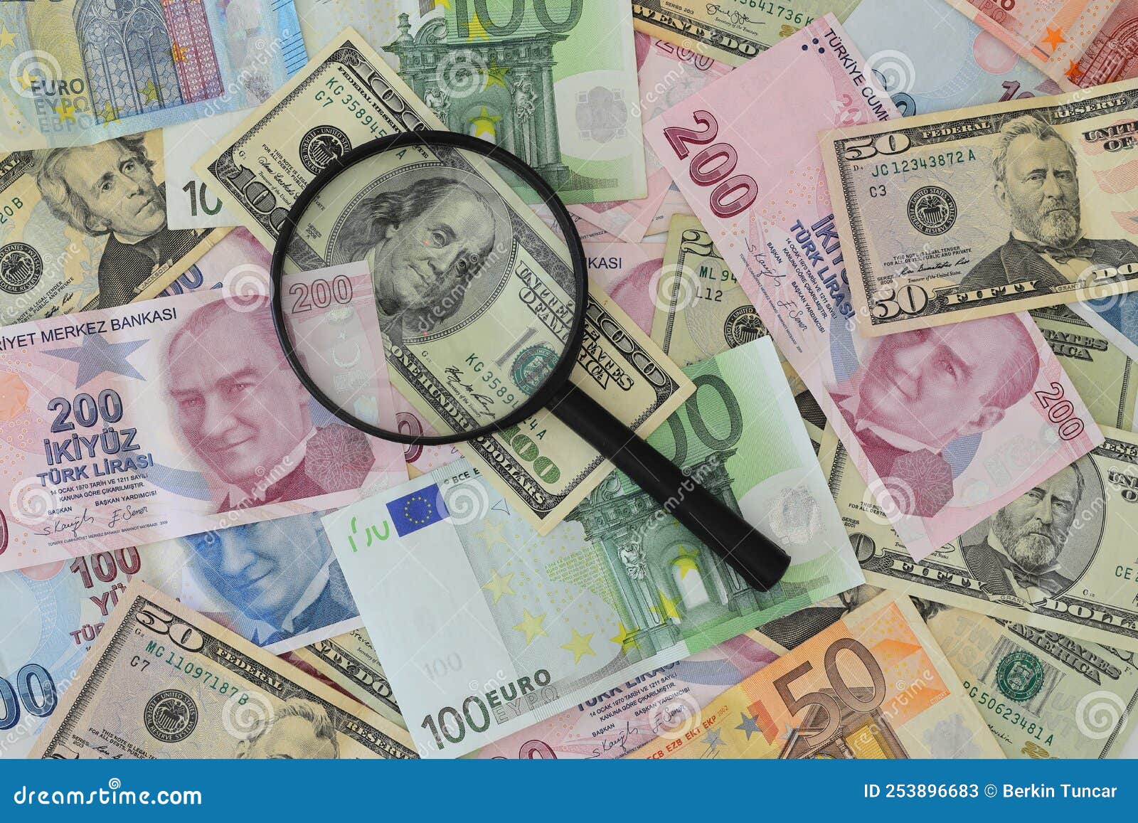 Banknotes Spread Out on a Table with a Calculator and a Magnifying