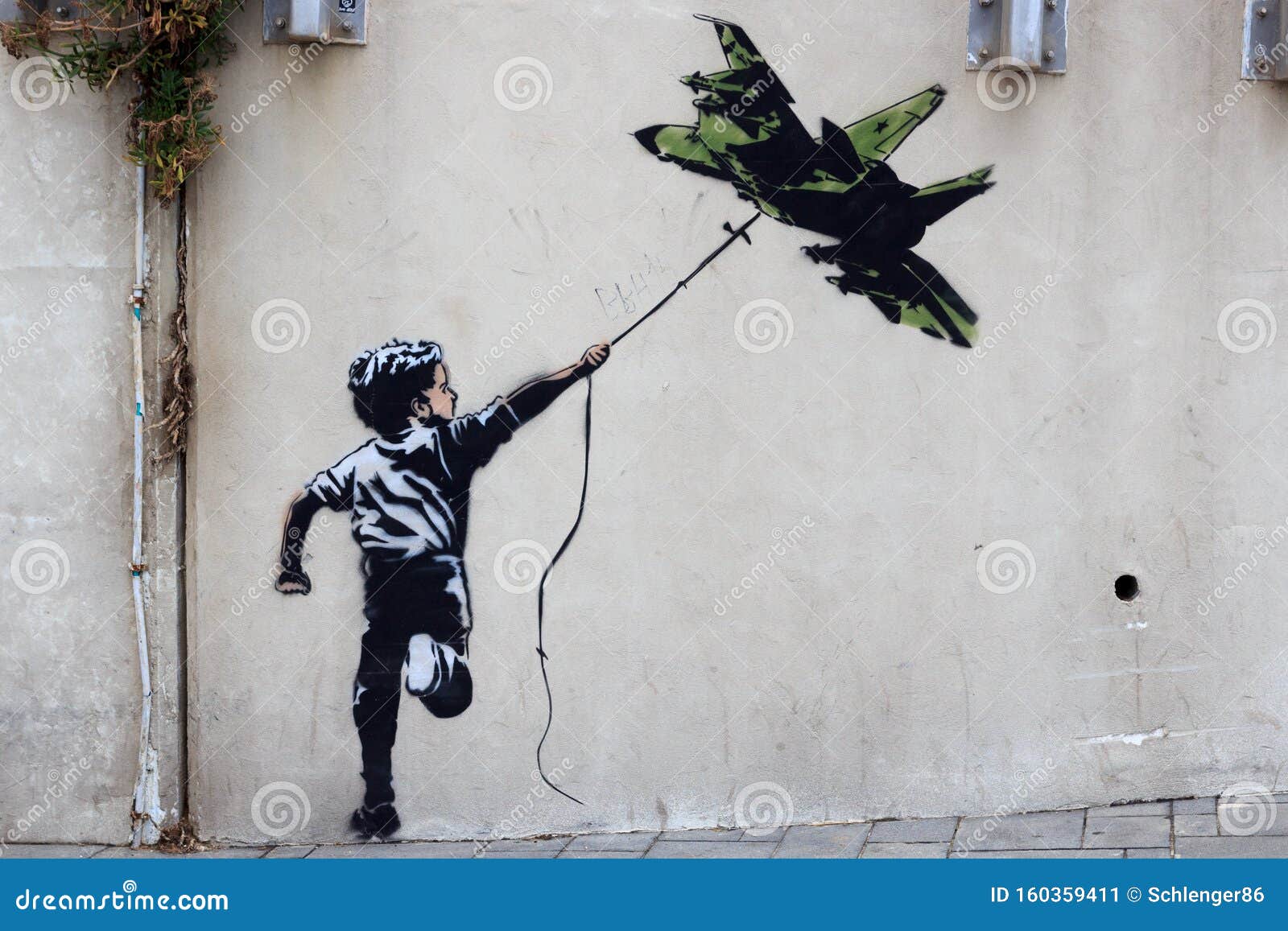 Banksy Street Art Graffiti Boy with Fighter Aircraft Kite in Tel Aviv, Israel Editorial Photo - Image of fighter, journey: 160359411
