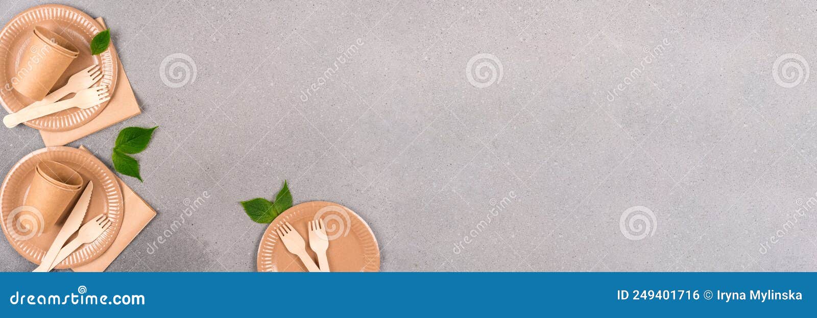 banner with paper and wooden tableware set - paper cups, plates and bamboo cutlery set over gray concrete background