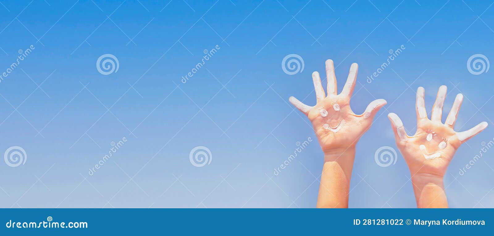 banner of positive  drawing by sunscreen (sun cream, suntan lotion) on two caucasians open hands o.