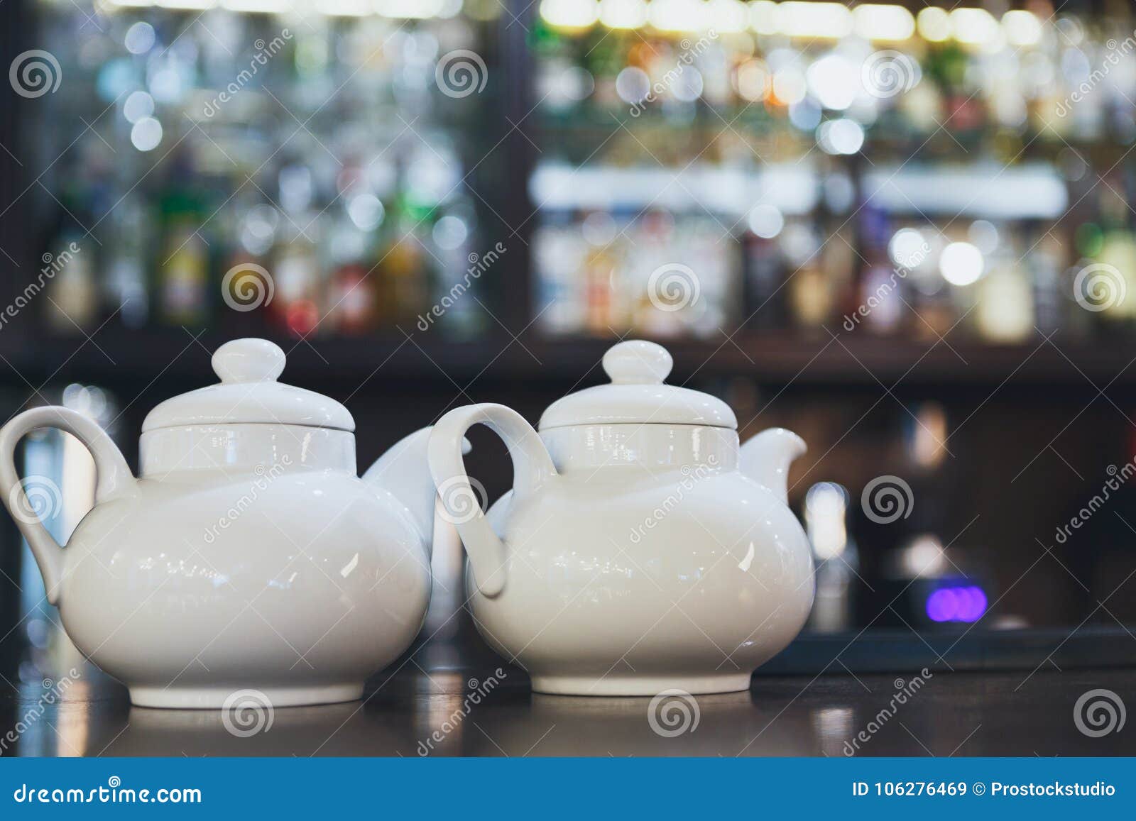 bar counter with two white teapots