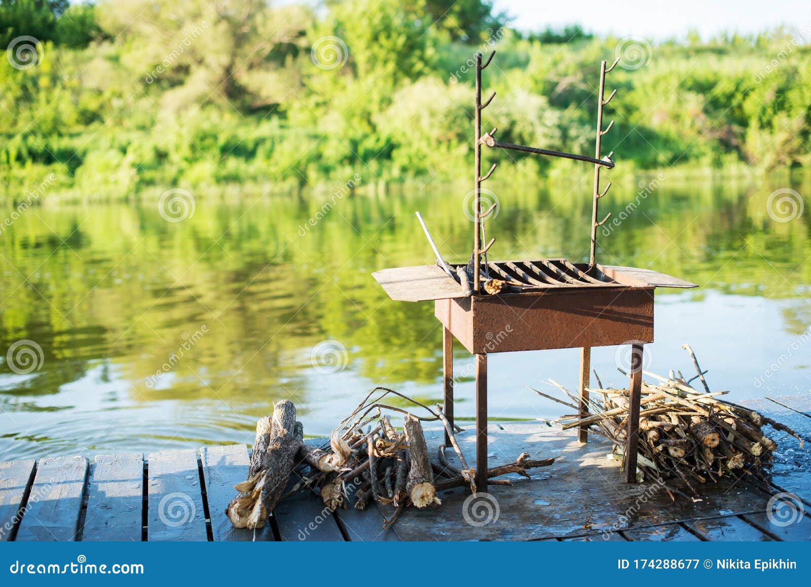 Barbecue Grill with Wood on the River in Beautiful Nature, on a Raft