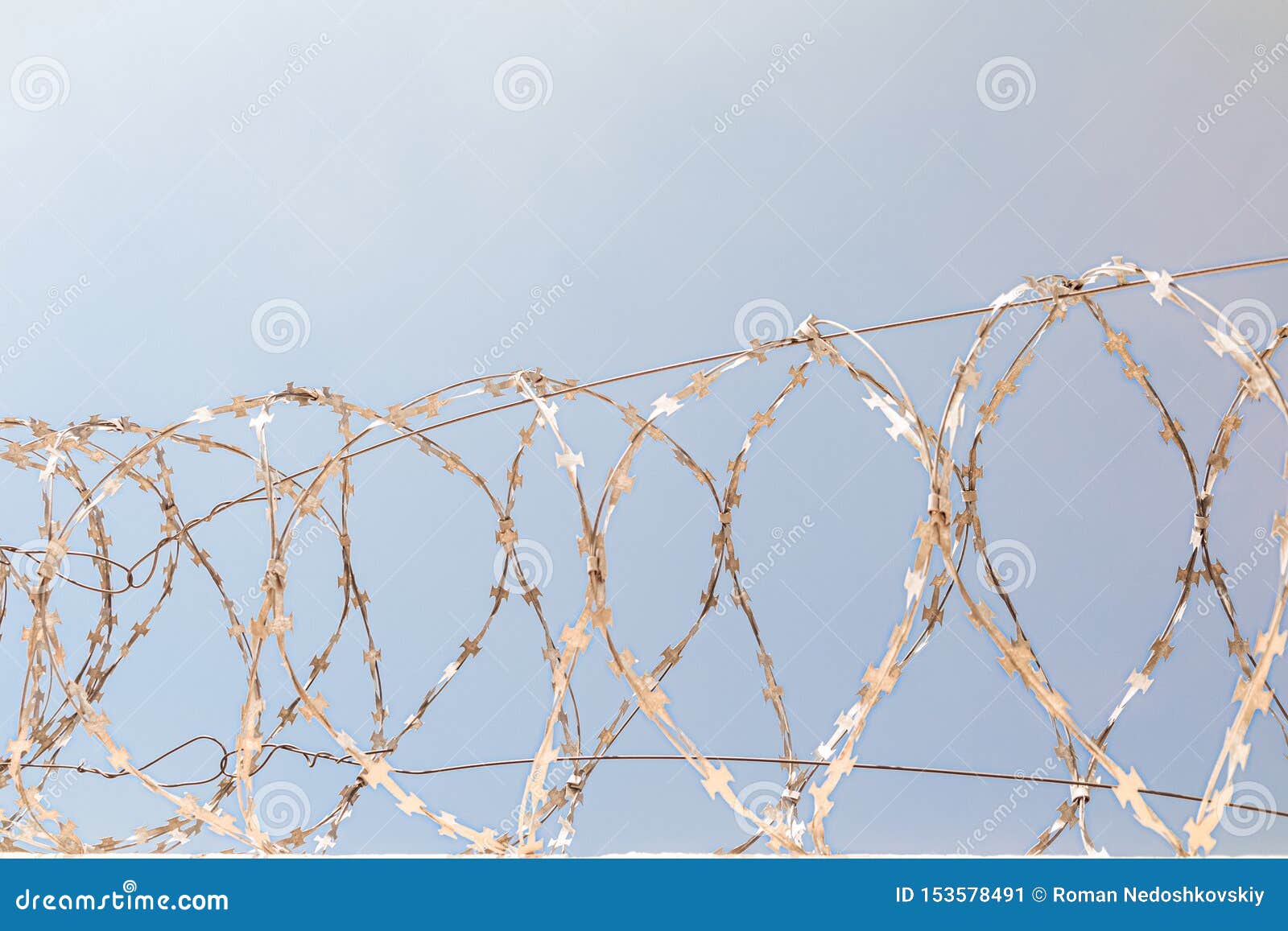 barbed wire on the fence. front view.