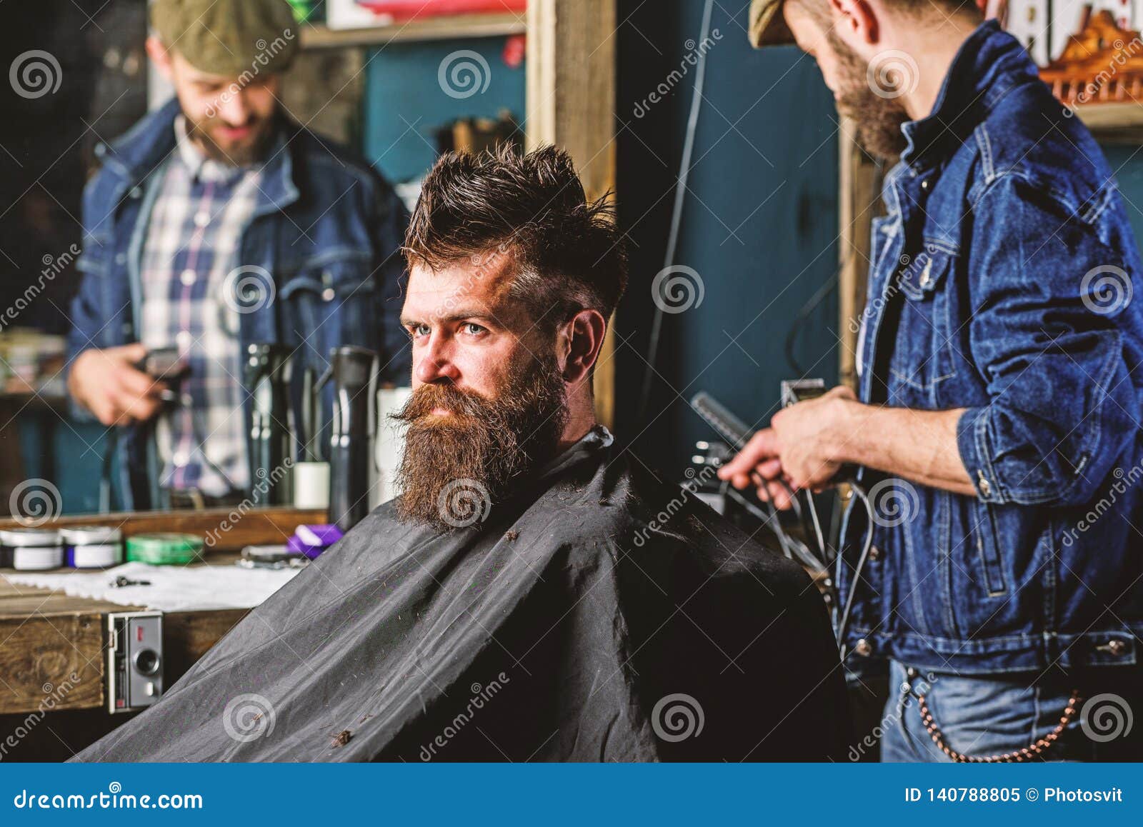 Barber with Clipper Styling Hair of Brutal Bearded Client. Hipster ...