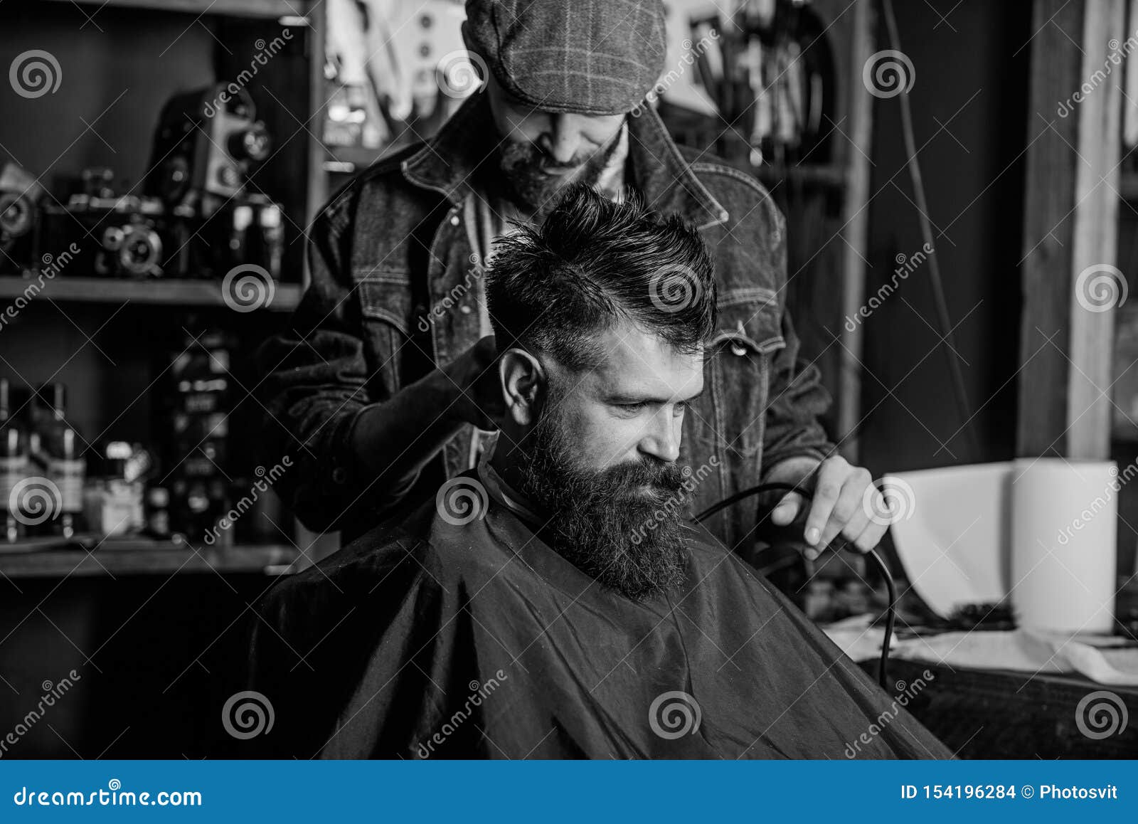 Barber with Hair Clipper Works on Haircut of Bearded Guy Barbershop ...