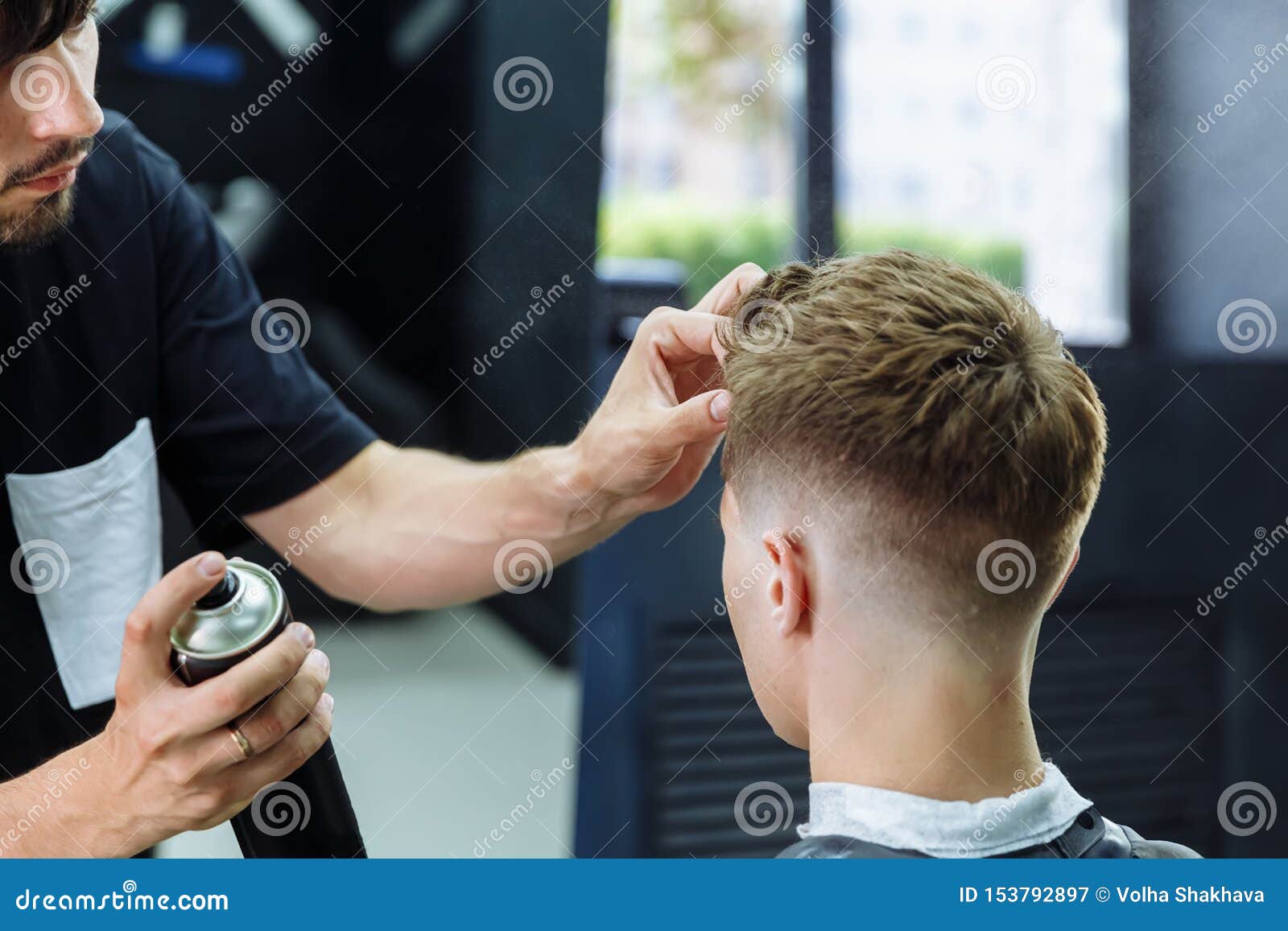 Barber Makes Hair Styling with Hair Spray after Haircut at the Barber Shop.  Young Handsome Caucasian Man Getting a Stock Image - Image of bangs, head:  153792897