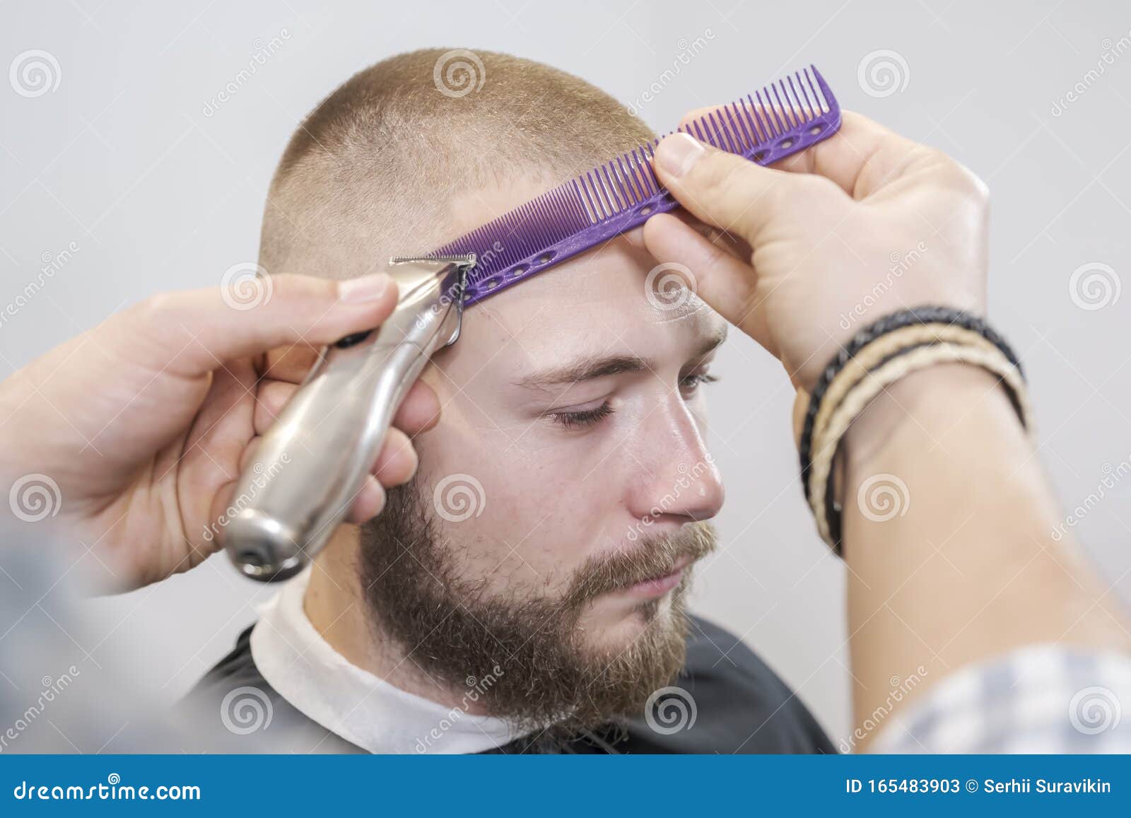 Barber Shaves the Client`s Head Using Electric Trimmer and Comb