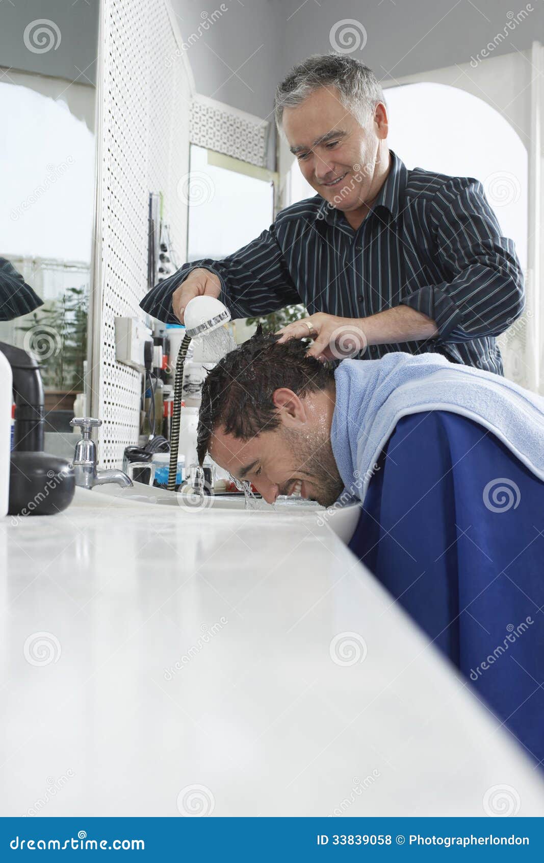 Barber Washing Man's Head stock photo. Image of looking 