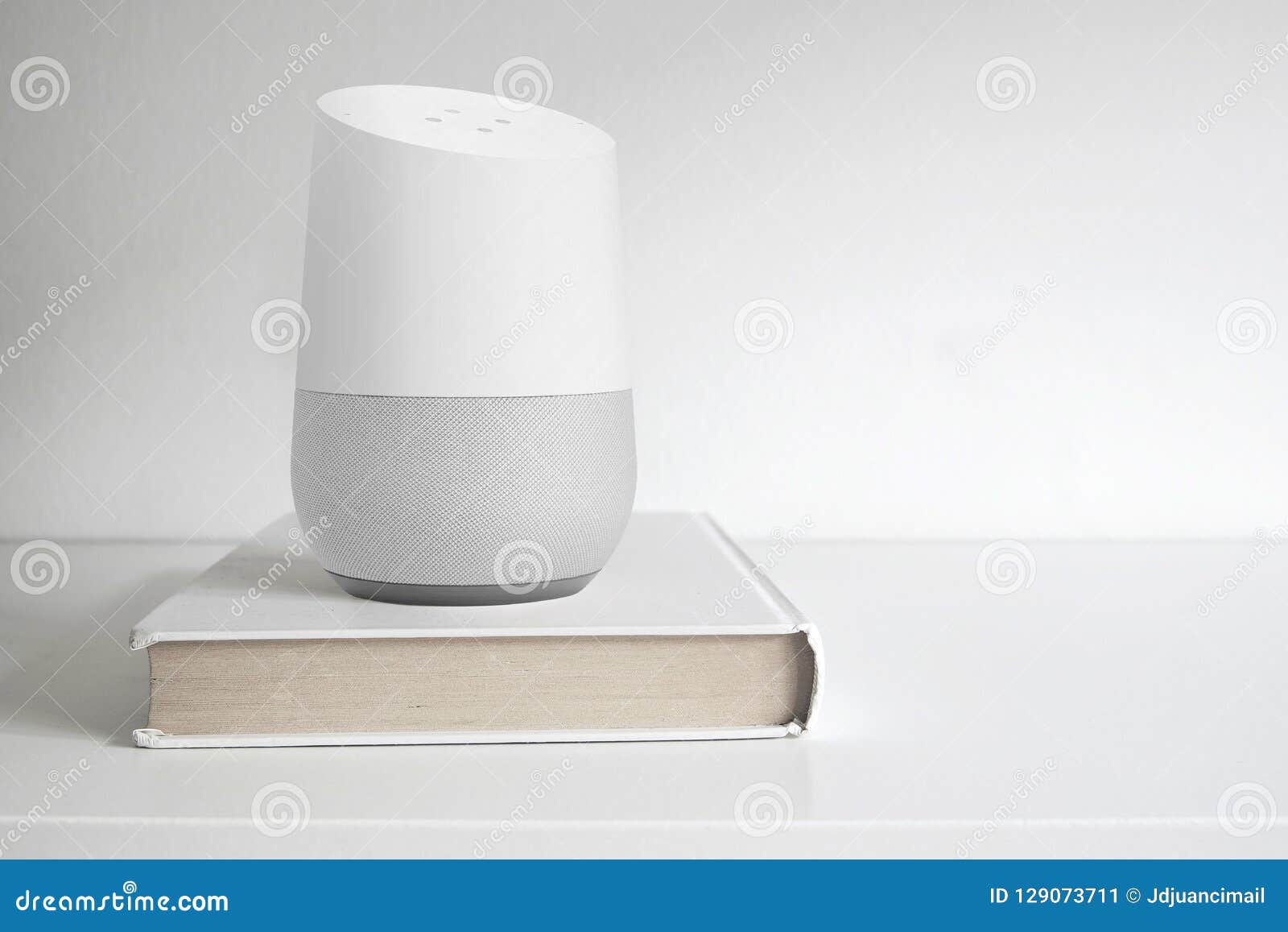 barcelona - september 2018: google home smart speaker on a book on a shelf