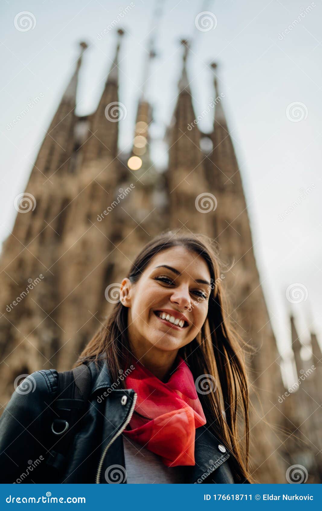 barcelona,spain-march 12 : smiling spanish woman visiting famous landmarks and attractions,gothic church sagrada familia,in center