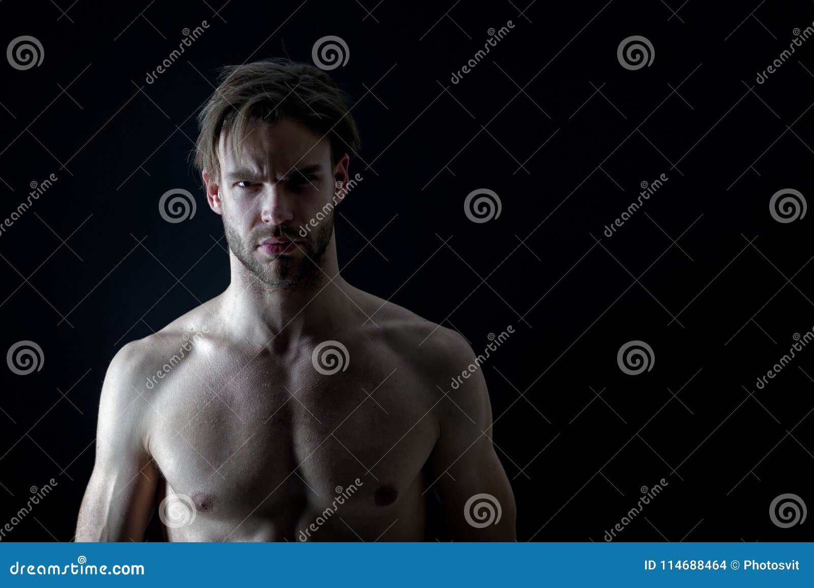 Bare Chested Muscular Man on Dark Background, Stock Photo Image of