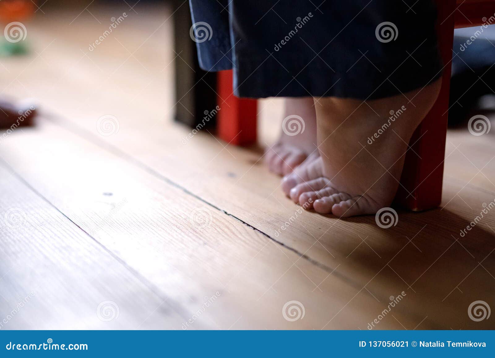 Boy`s feet on the floor stock image. Image of guidance 137056021