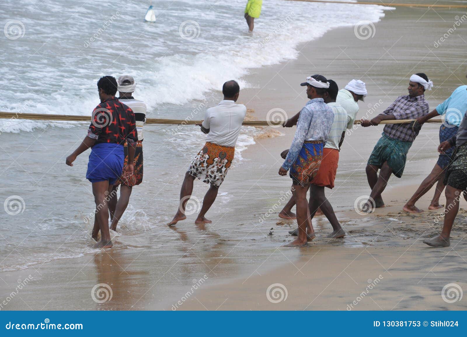 Fishermen Pulling Their Net To Shore Editorial Stock Photo - Image