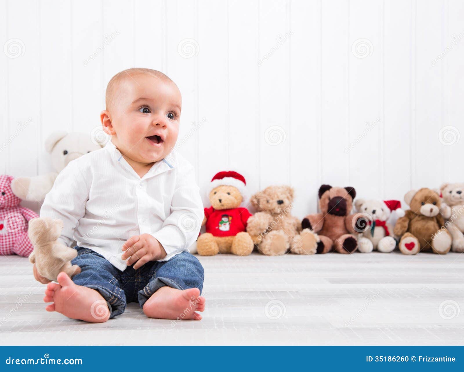 barefoot baby on white background with cuddly toys - cute little