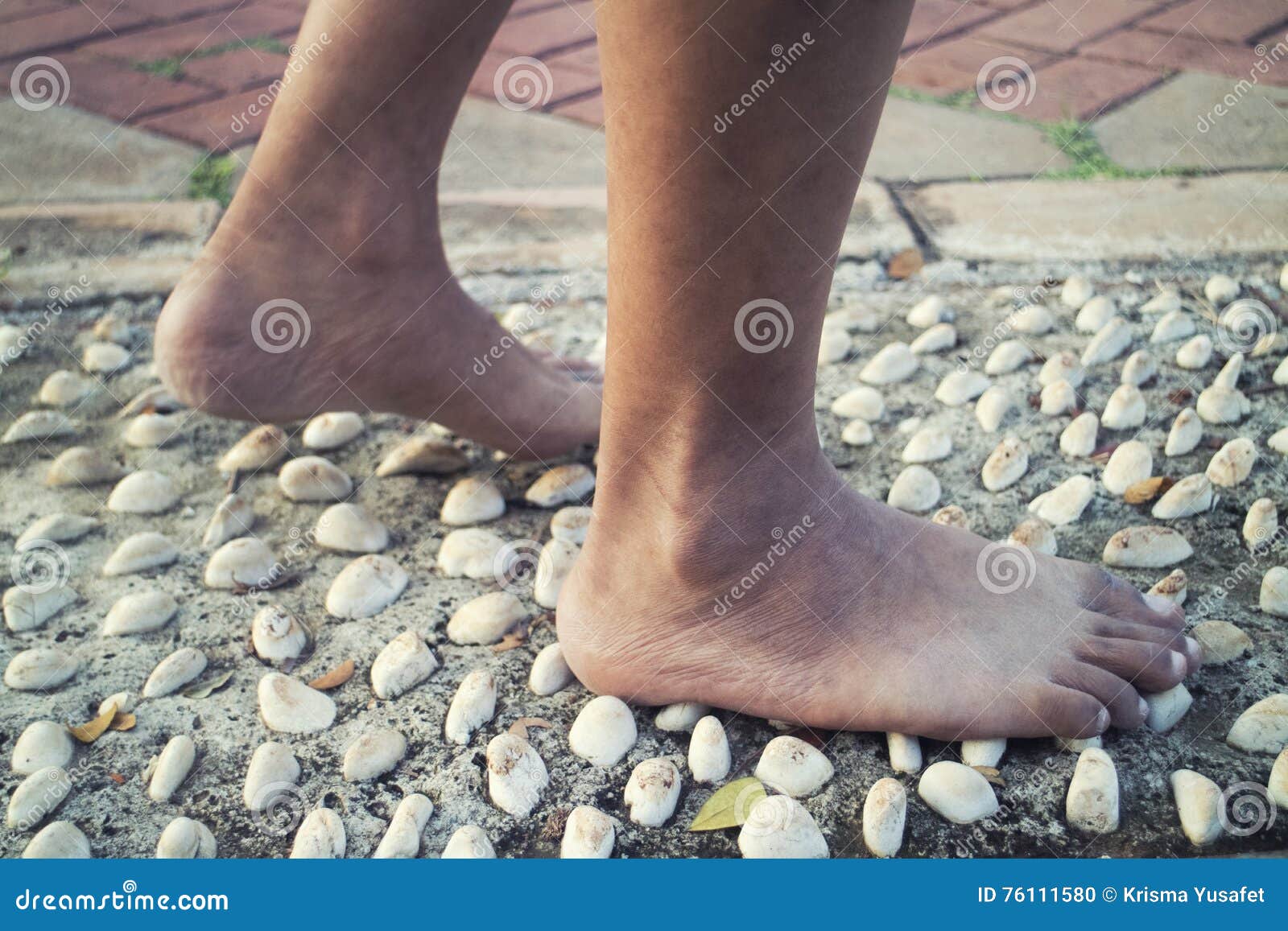Barefoot at Cement Stone Track for Massage the Soles of the Feet from