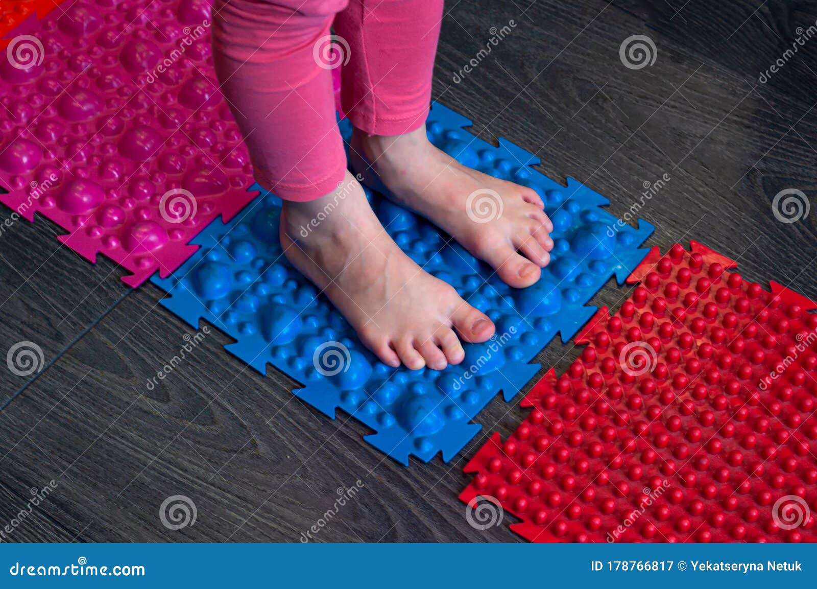 barefoot girl walks on sensory mats in the sensory integration room