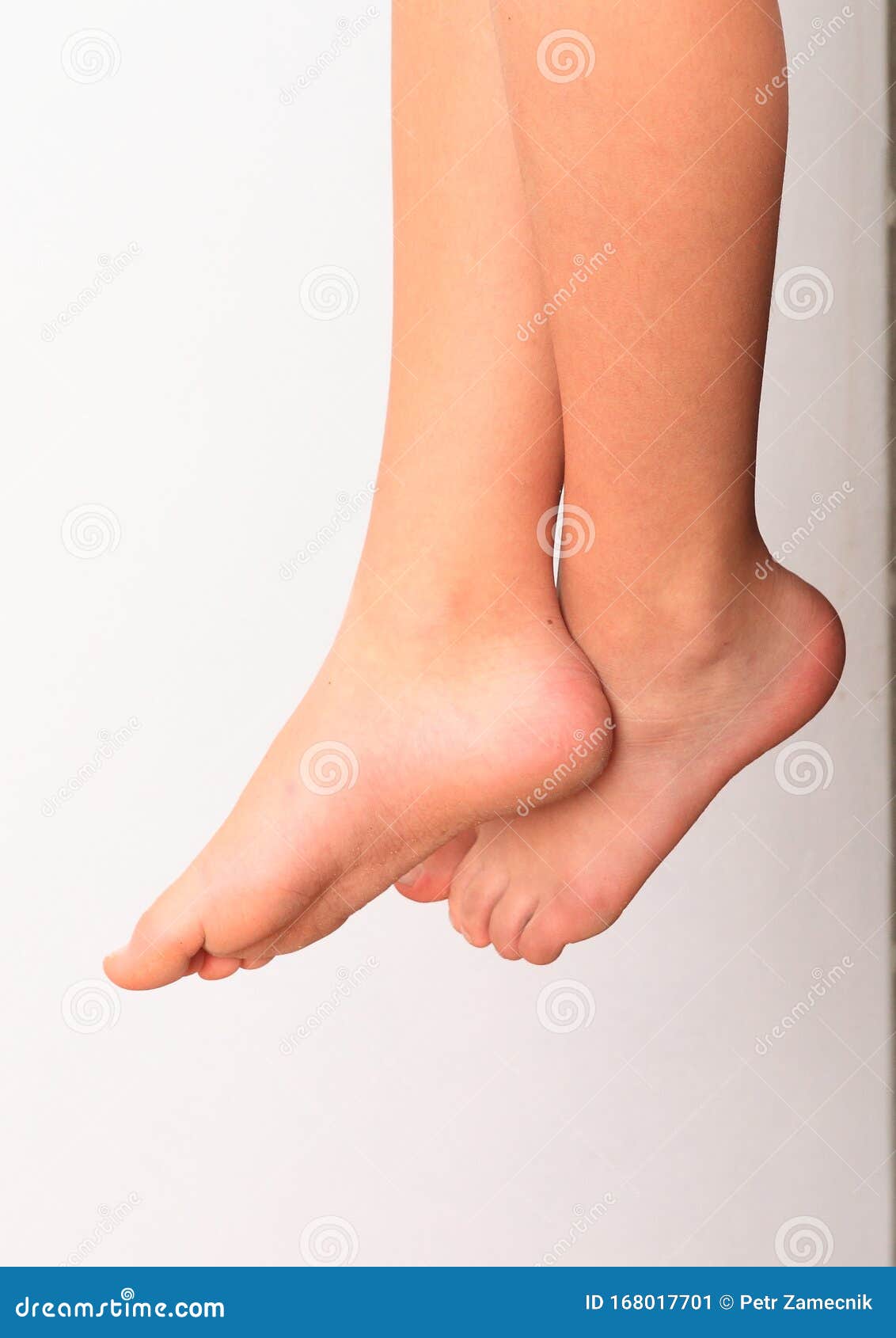 Bare Feet of a Little Girl Hanging in the Air Stock Image - Image