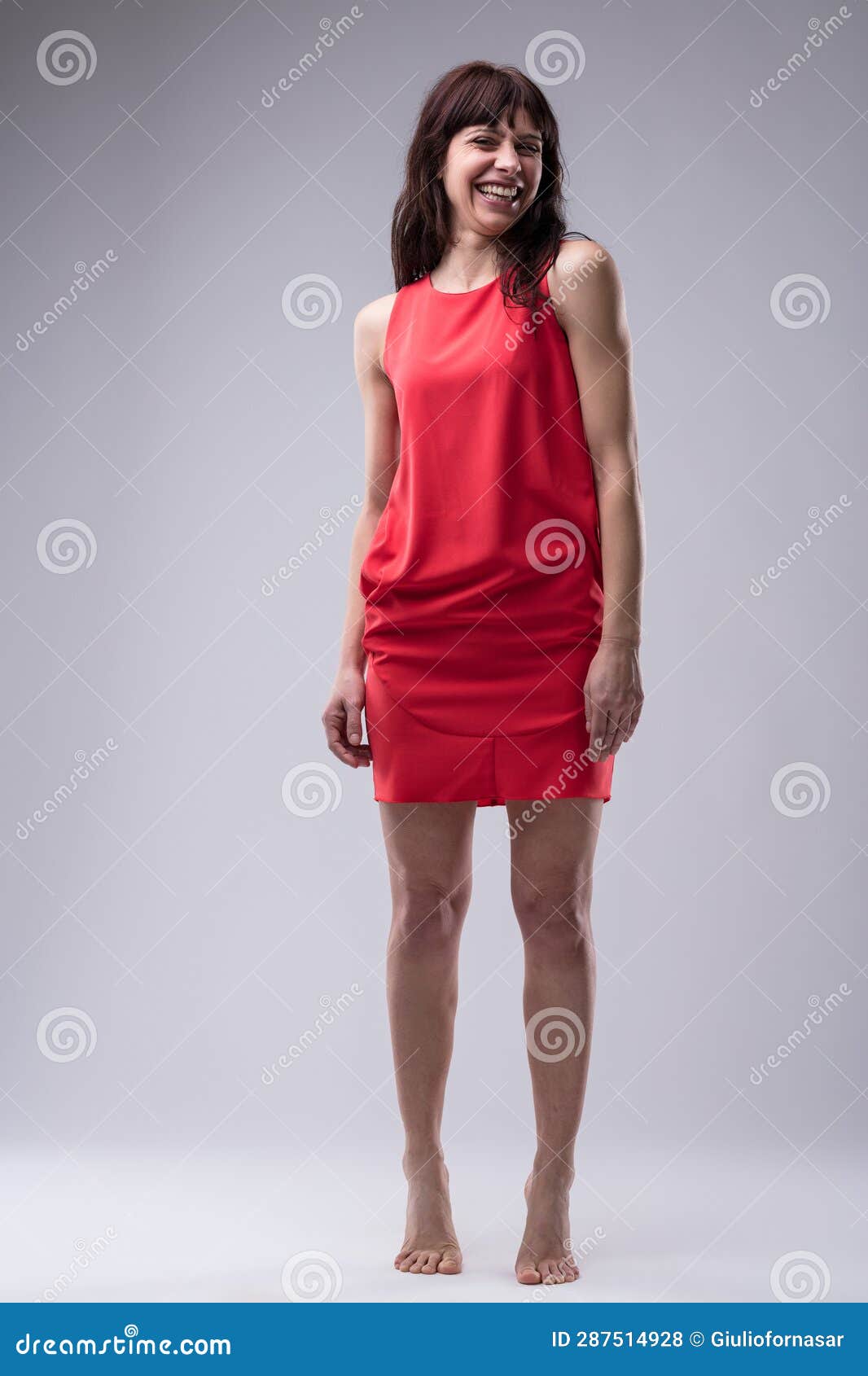 barefoot woman in red acts youthfully