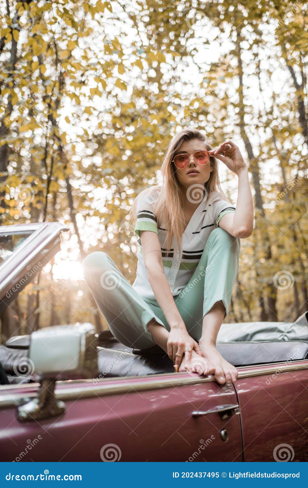 https://thumbs.dreamstime.com/z/barefoot-woman-touching-sunglasses-posing-cabriolet-forest-blurred-foreground-stylish-202437495.jpg