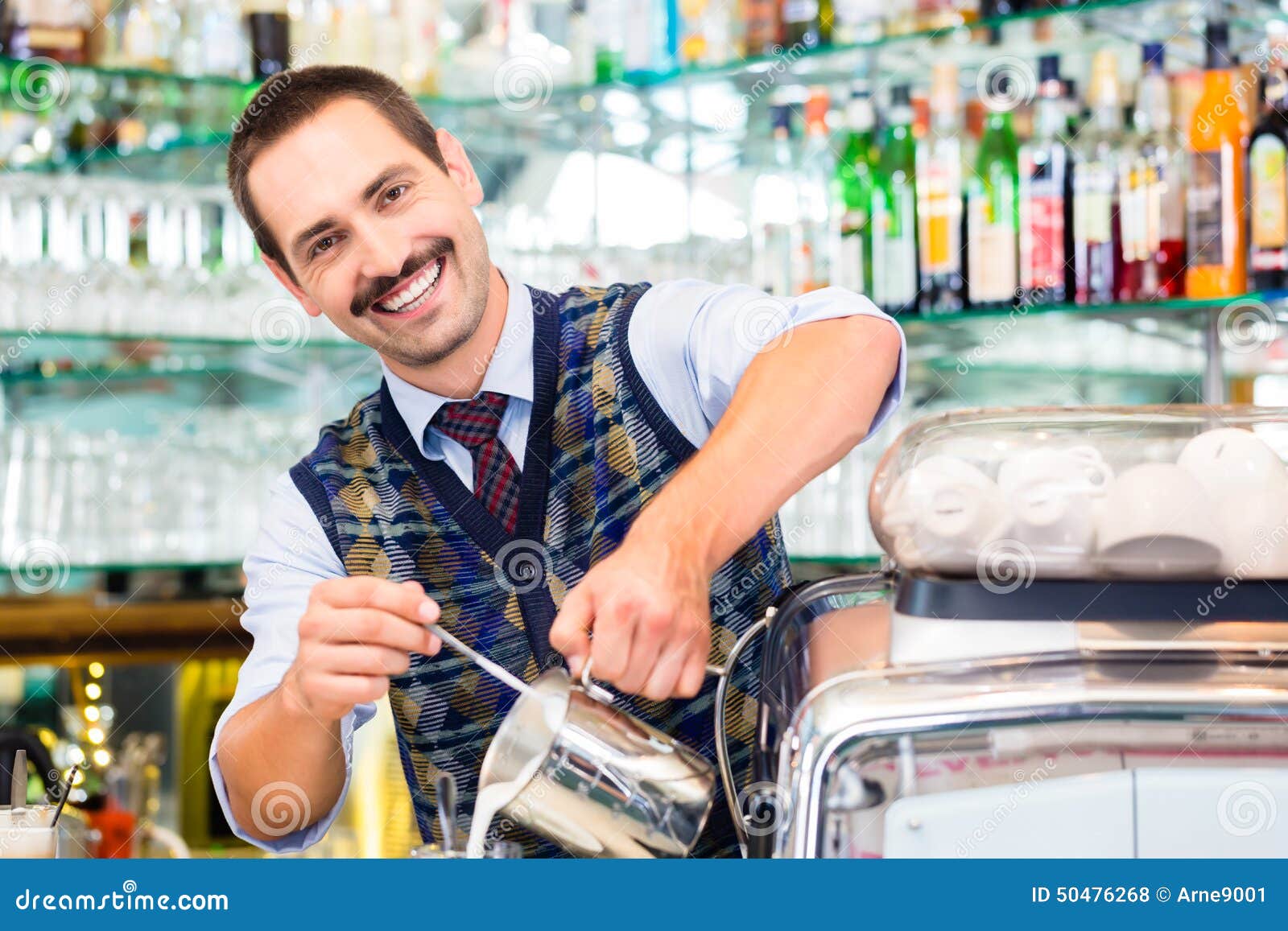 barista in cafe pouring espresso shot in latte macchiato