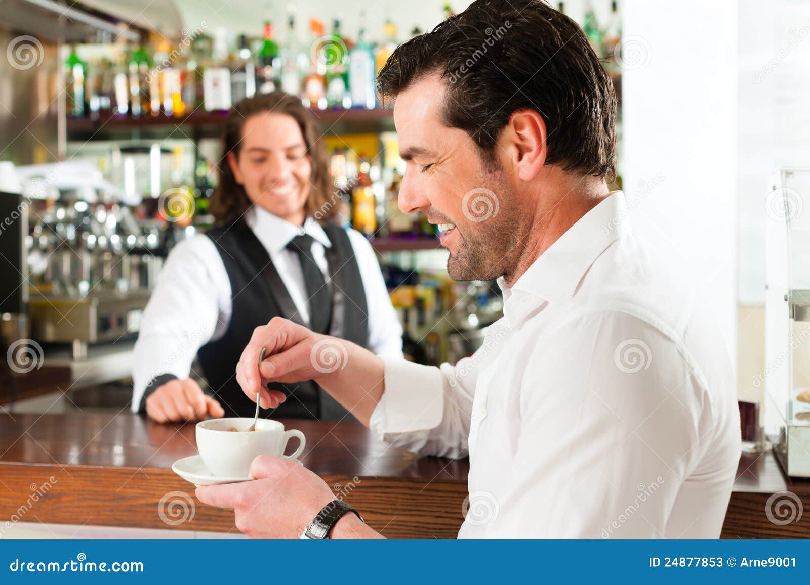 barista with client in his cafe or coffeeshop