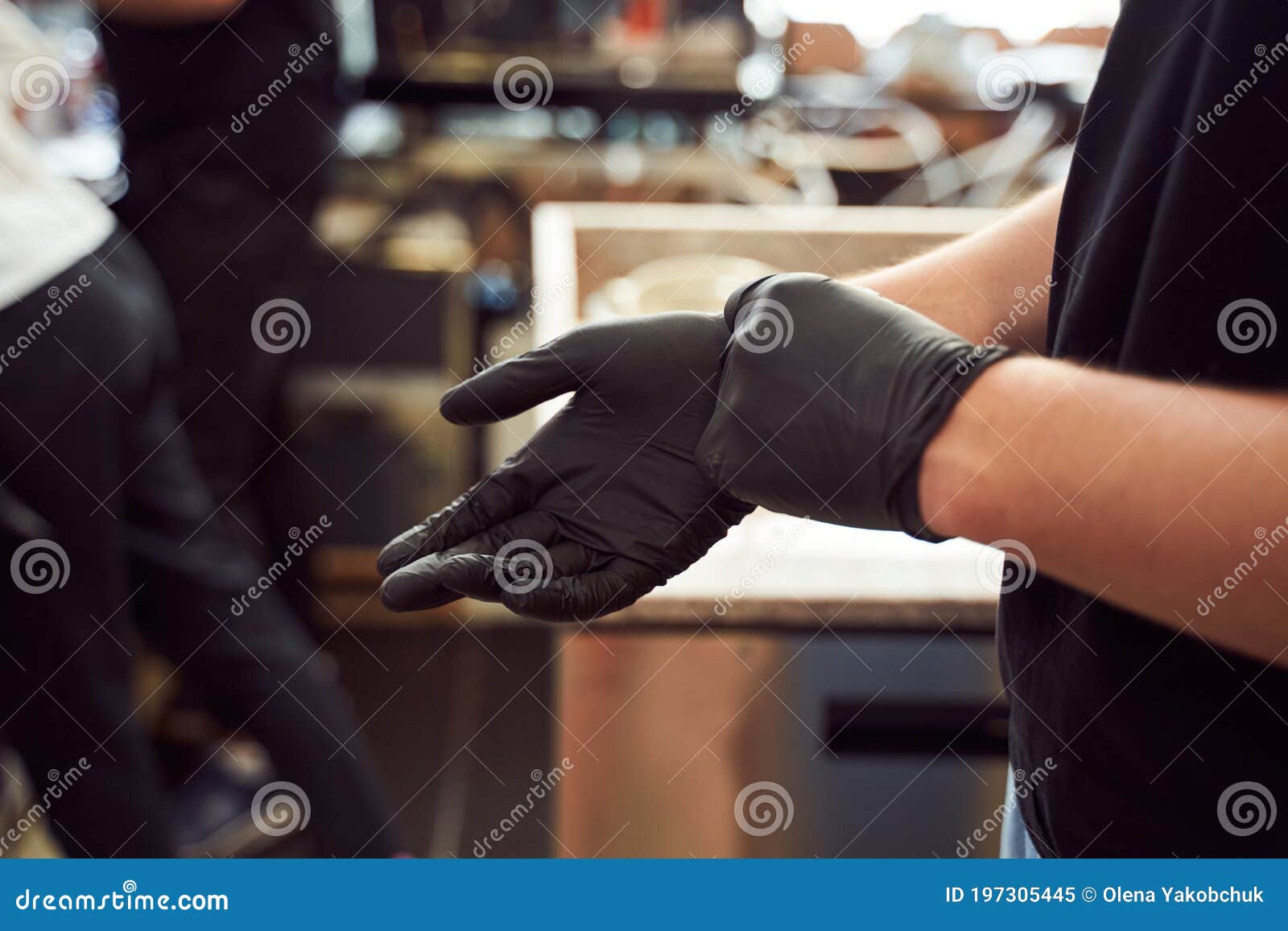 barista hands in black gloves