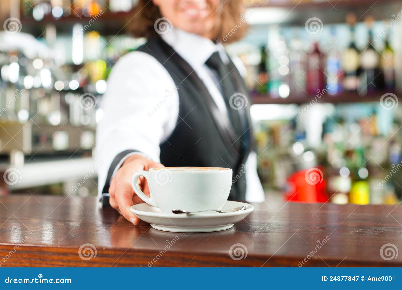 barista making cappuccino in his coffeeshop