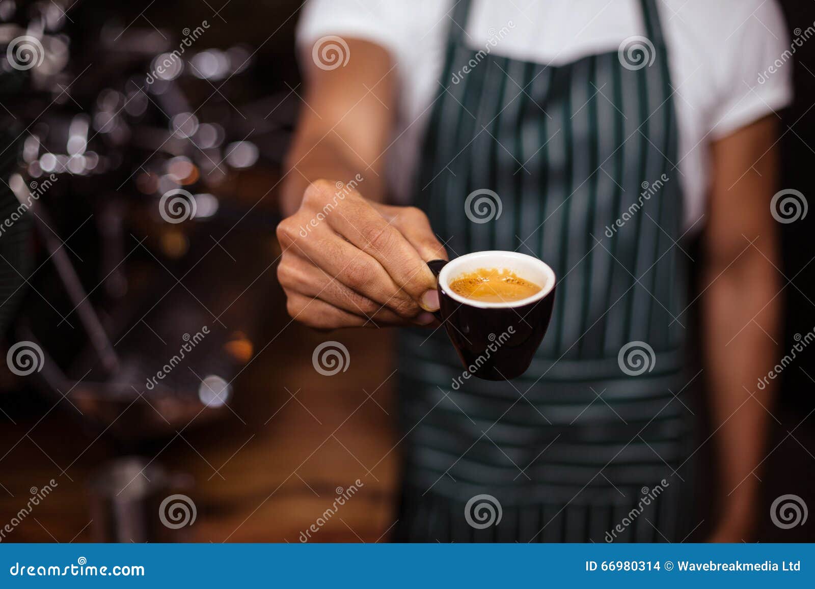 barista offering an espresso