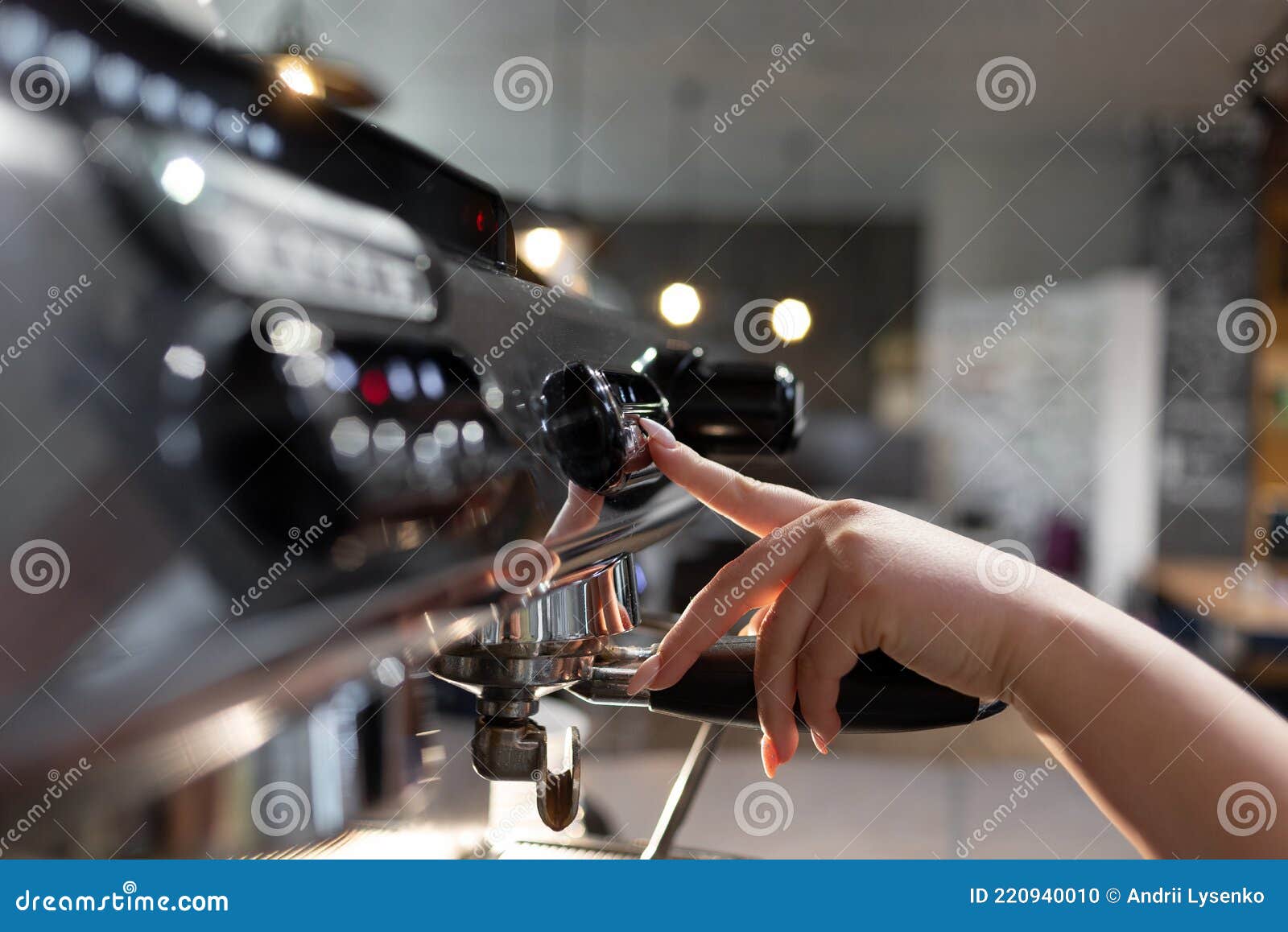 A Barista Prepares a Professional Coffee Machine for Work in a