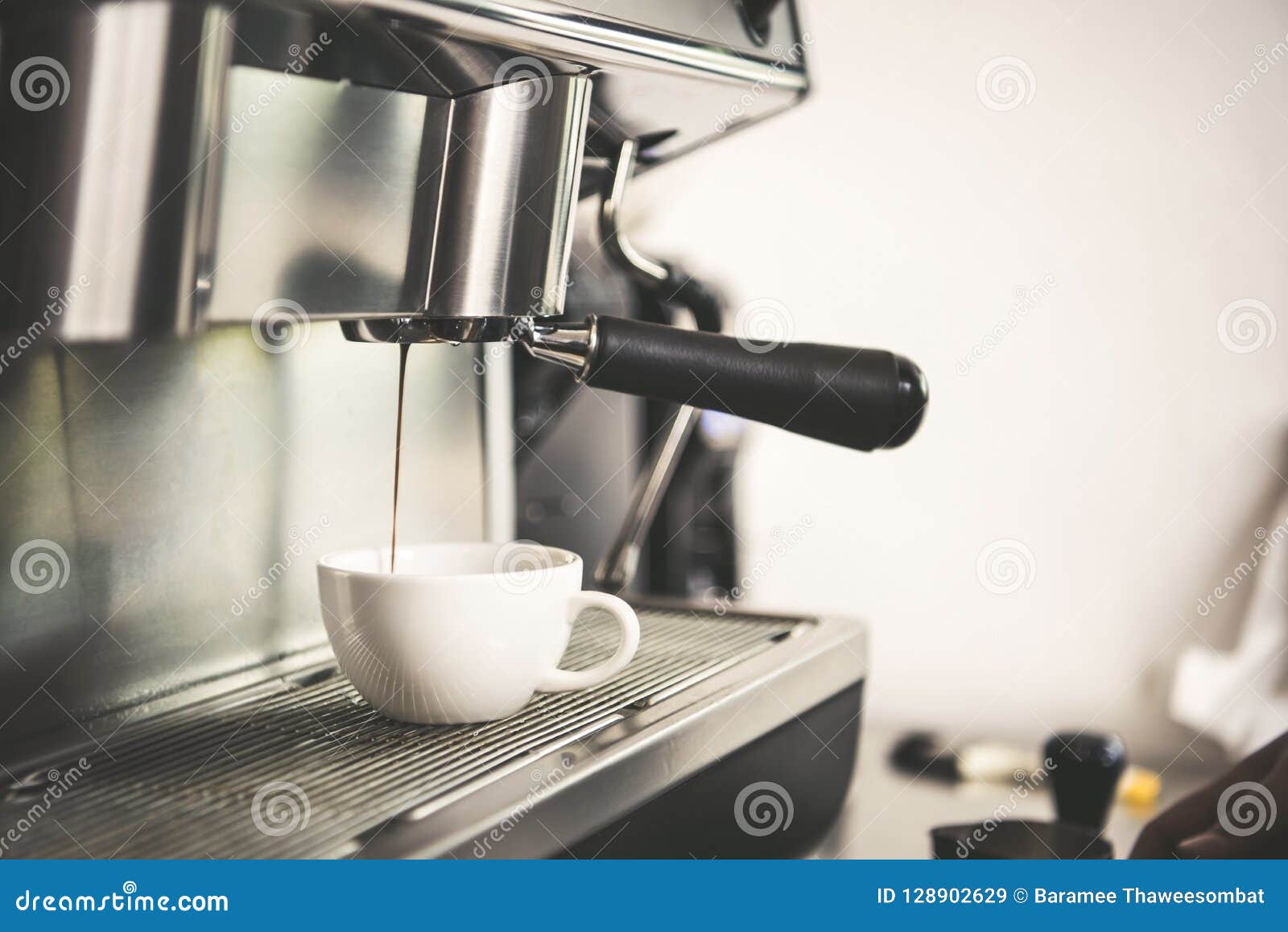 Barista Using Coffeemaker Extraction for Espresso Shot in Cafe Stock
