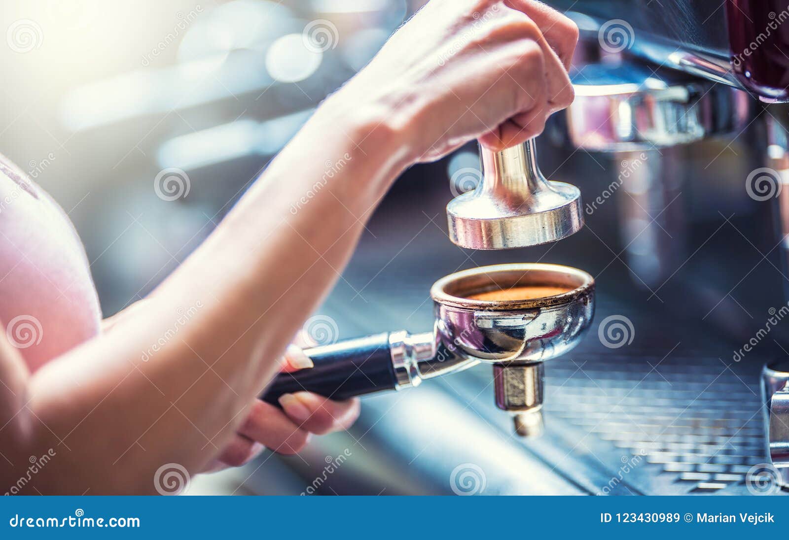 barista woman making an espresso coffee.