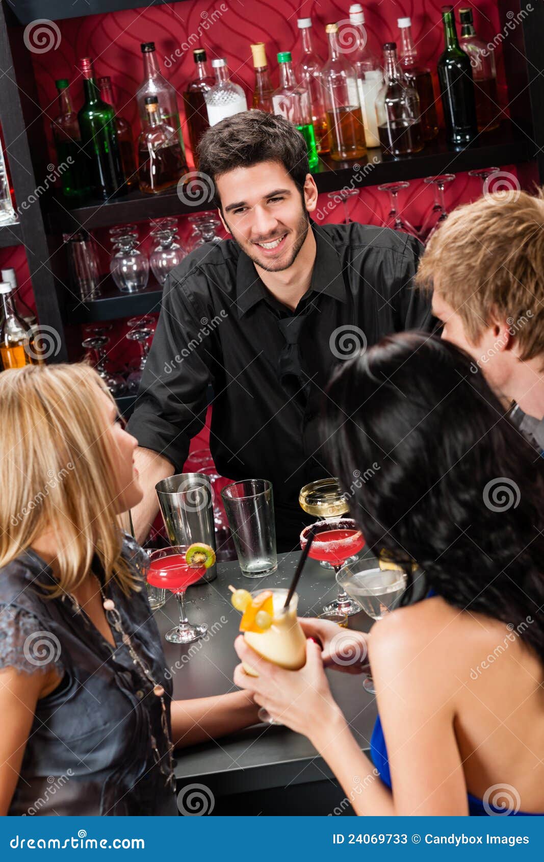 barman chatting with friends drinking at bar