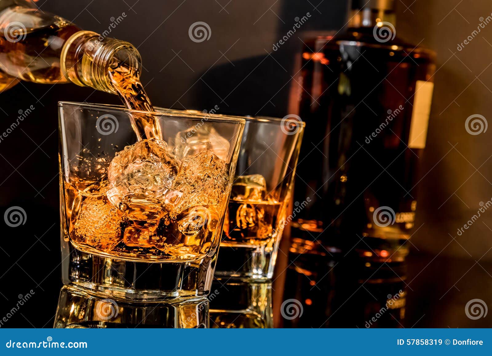 barman pouring whiskey in front of whiskey glass and bottles