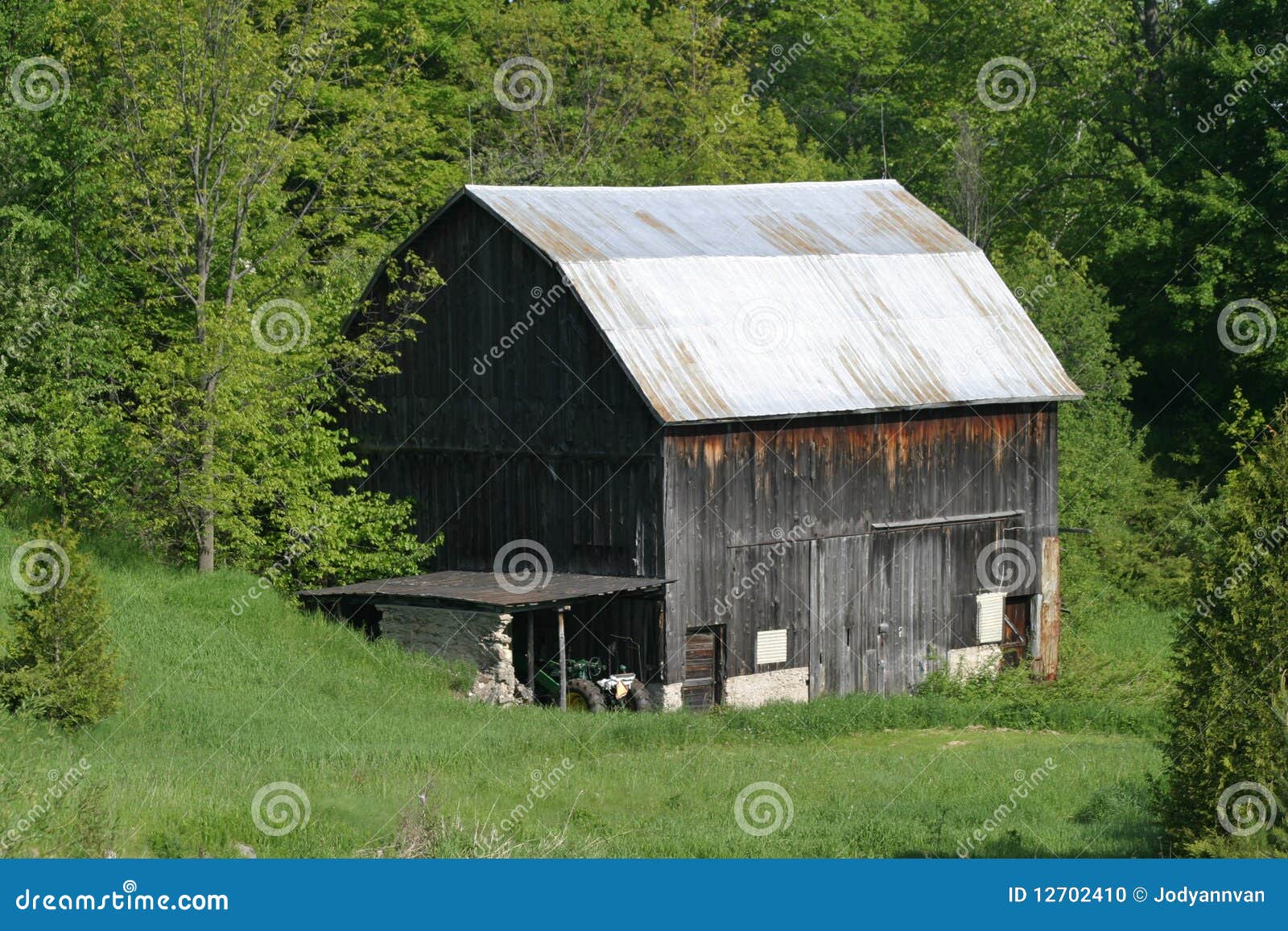 Barn with silver tin roof stock photo. Image of lush 12702410