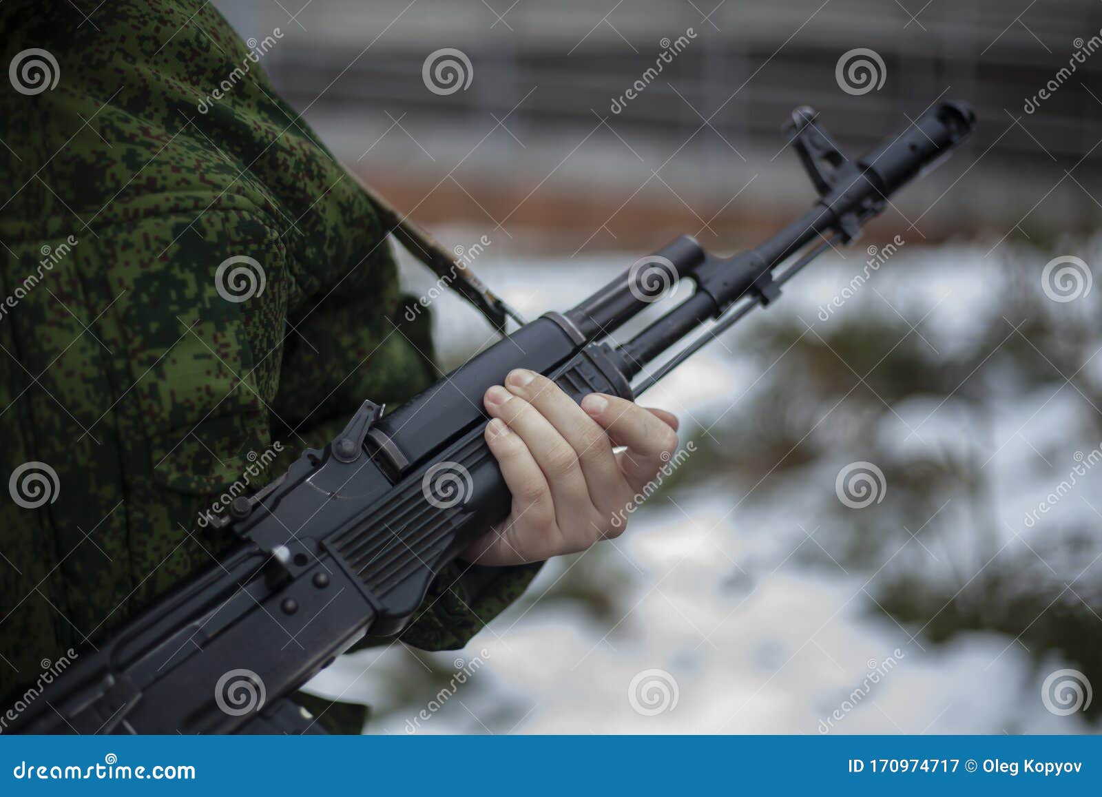 the barrel of an assault rifle. the weapon in the hands