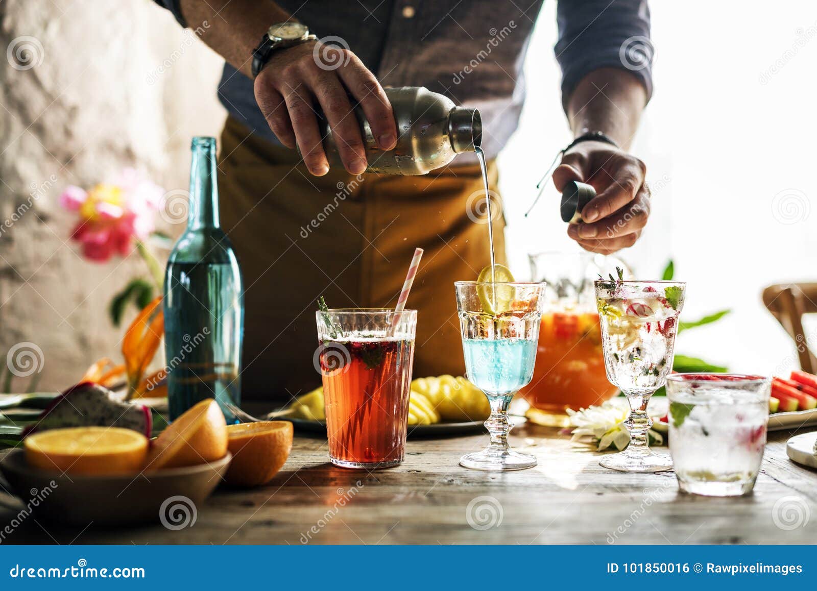 bartender mixing colorful cocktails