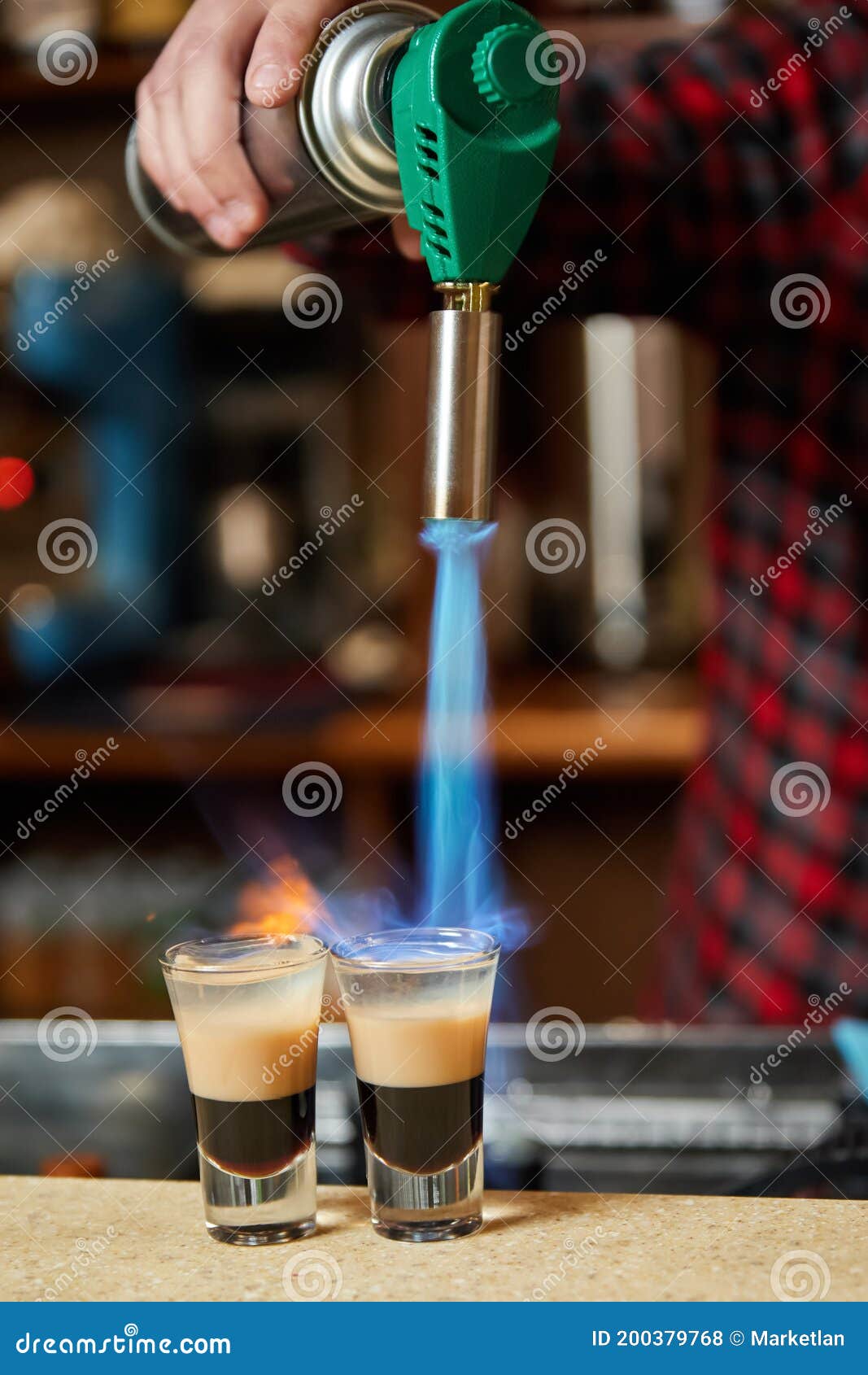 Bartender Sets Fire the Alcoholic Drink with Gasburner Stock Photo