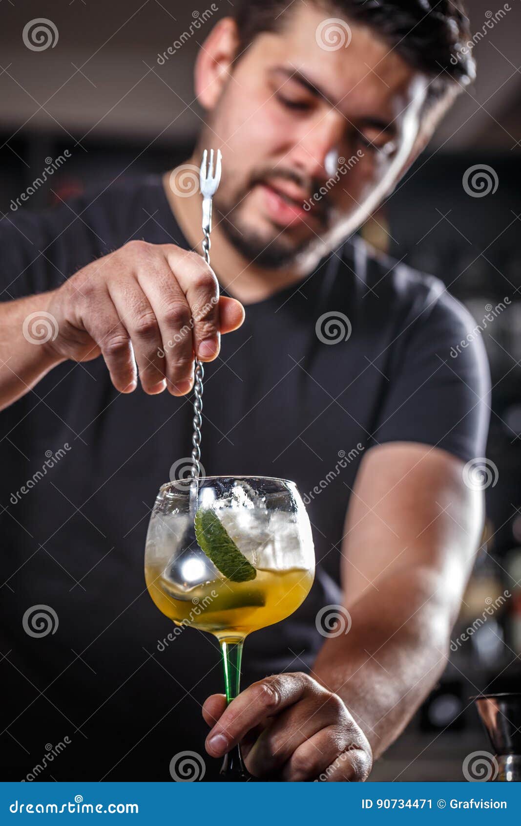 Bartender is stirring cocktails on bar counter