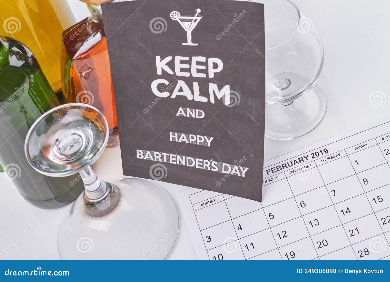 bartenders day concept. february calendar and many alcoholic drinks.