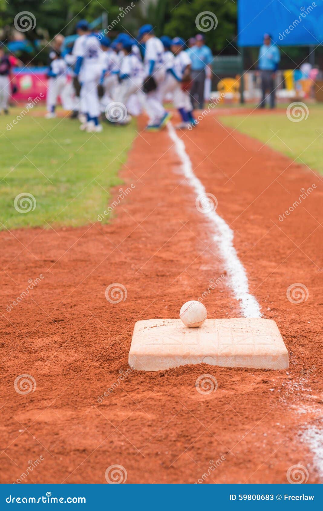 Baseball and Base on Baseball Field with Players and Judges Stock Image